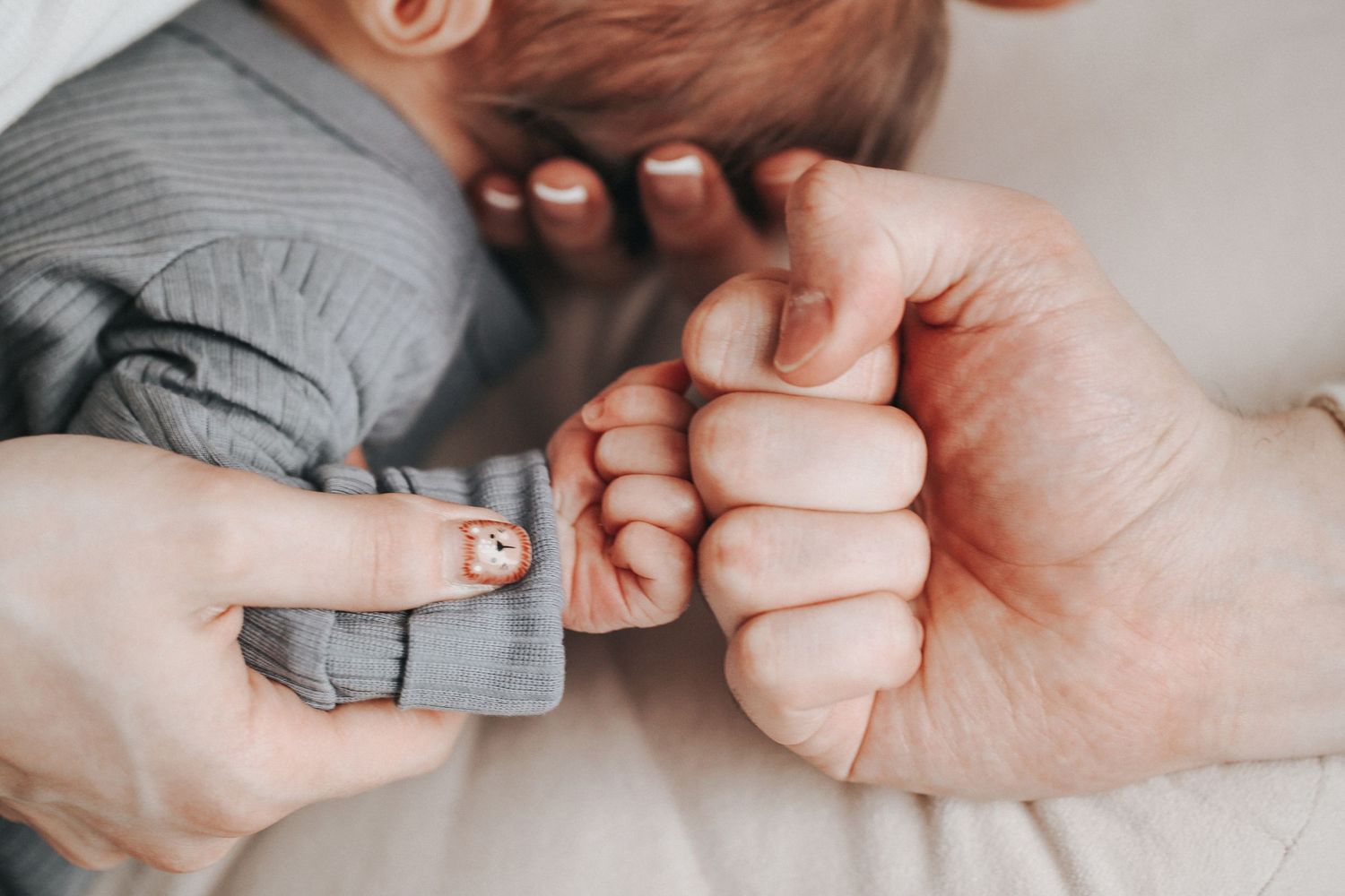 Close up shot of tiny baby toes being held by gentle hands.