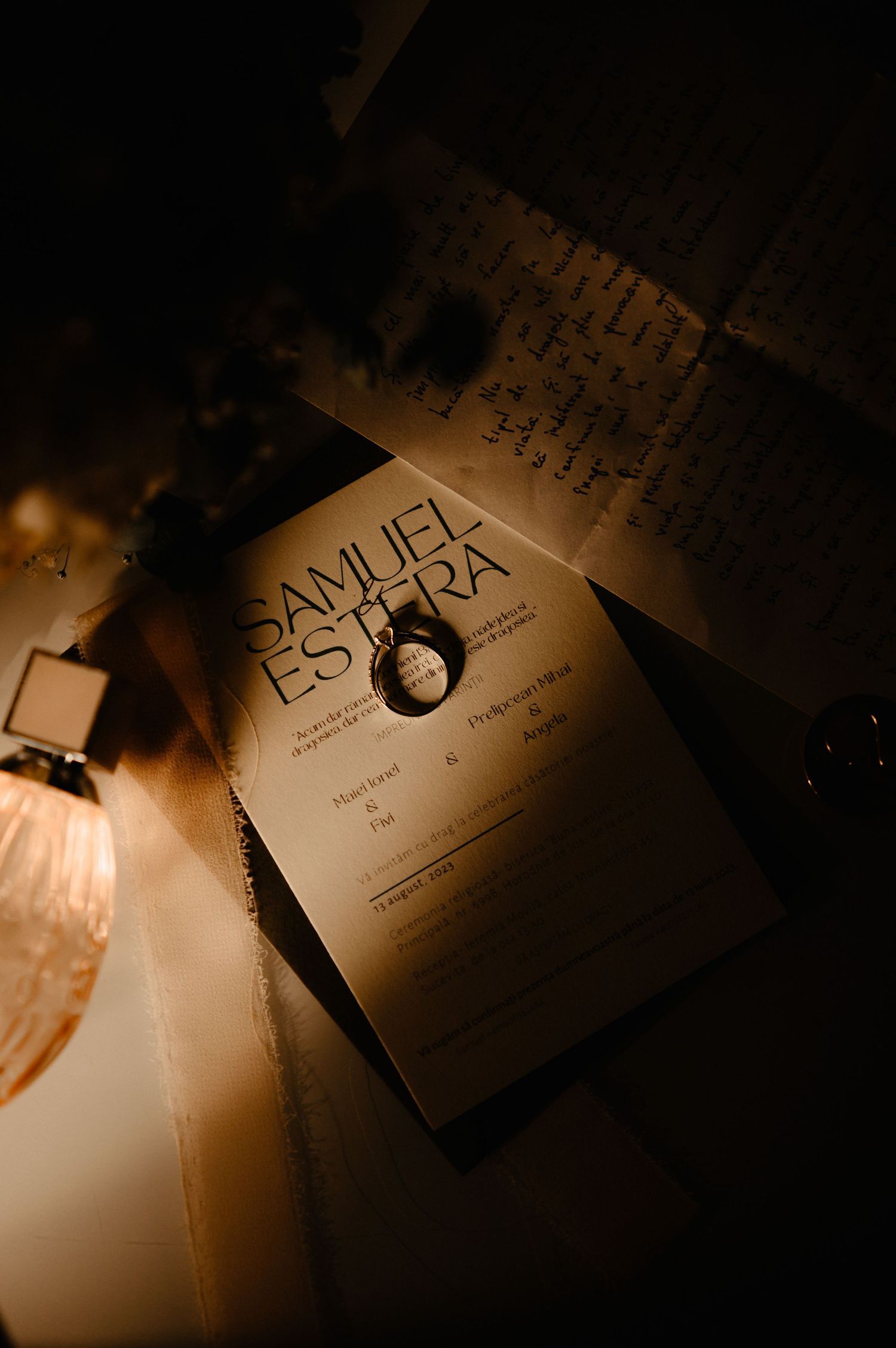 Wedding program for Samuel and Estera with a ring resting on top in candlelight.