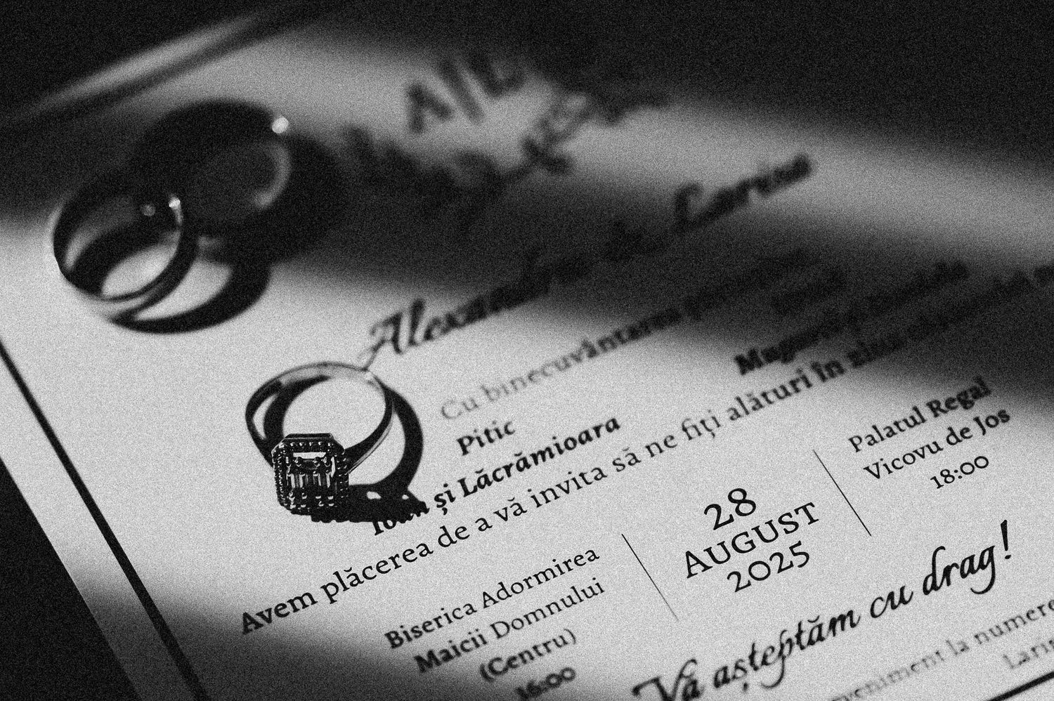 Black and white wedding invitation with rings for August 28 2025 ceremony.