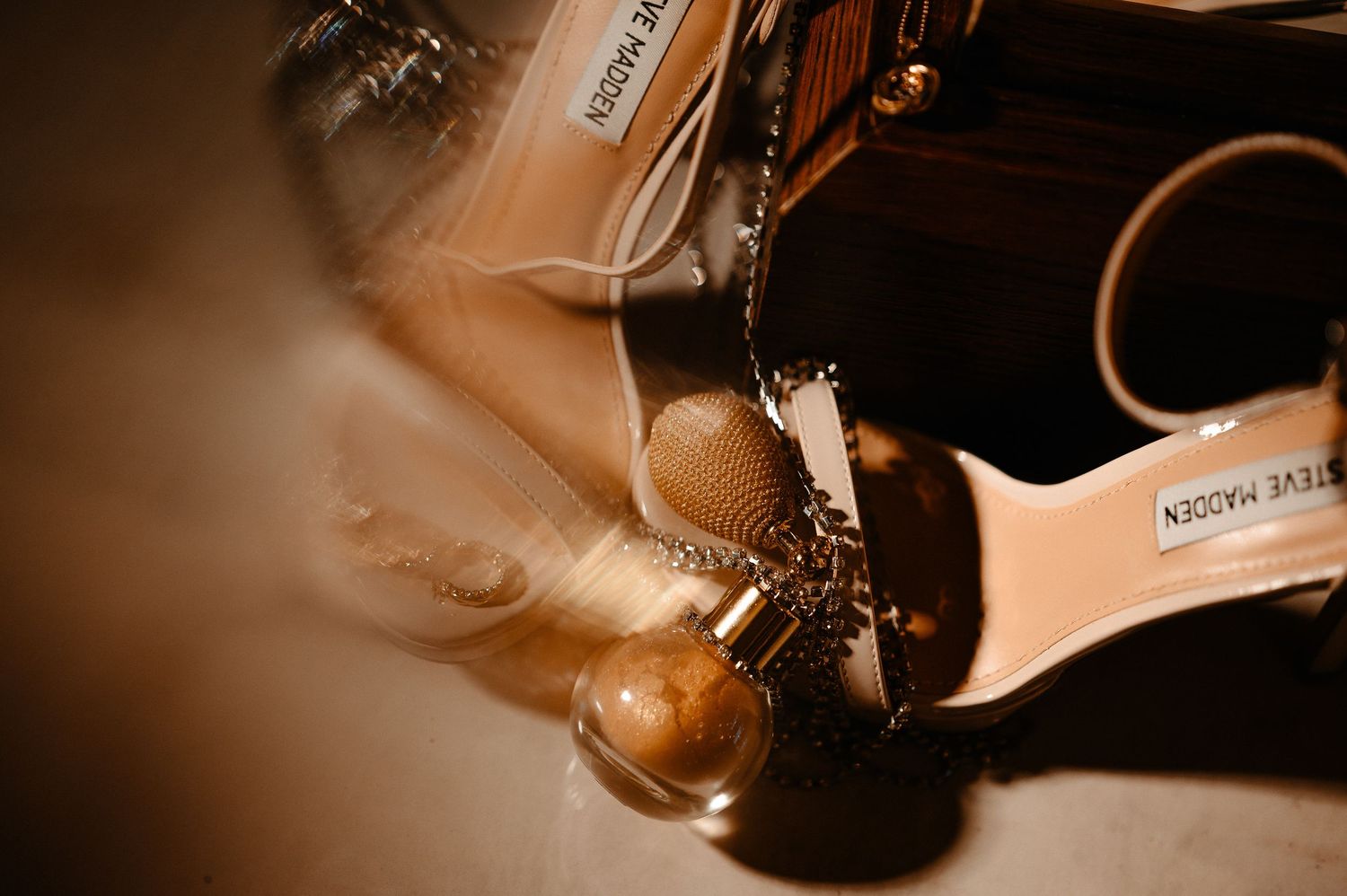 Close-up of Steve Madden gold strappy bridal heels with elegant wedding accessories detail shot.