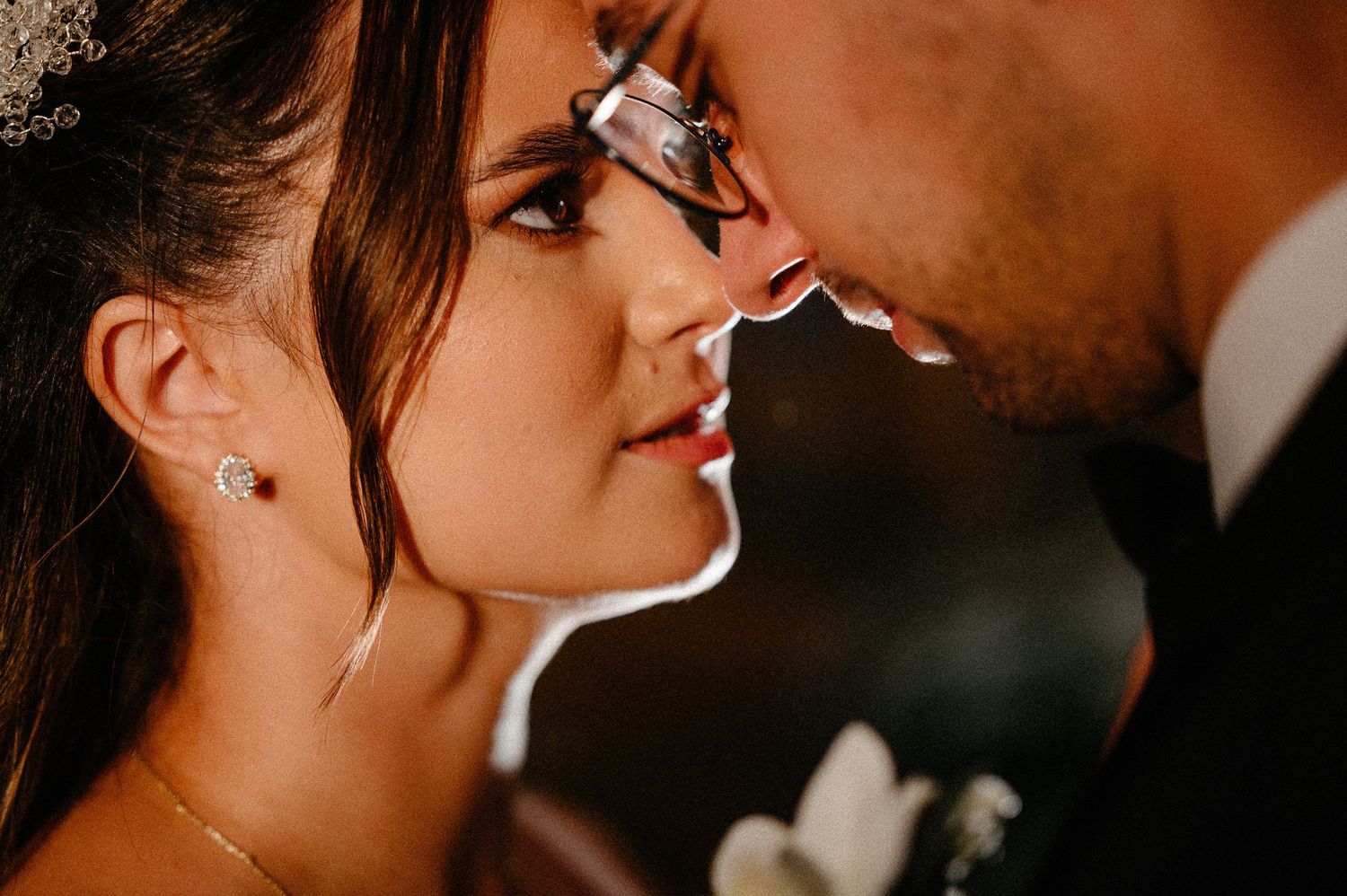Close-up of bride and groom touching foreheads intimately during their wedding celebration.