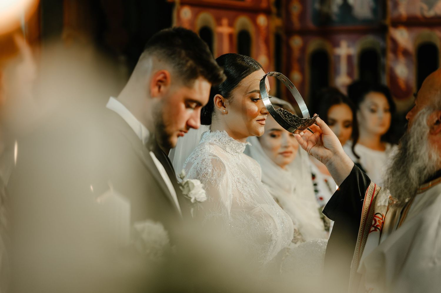 Orthodox priest placing crown on bride during traditional wedding ceremony in church.
