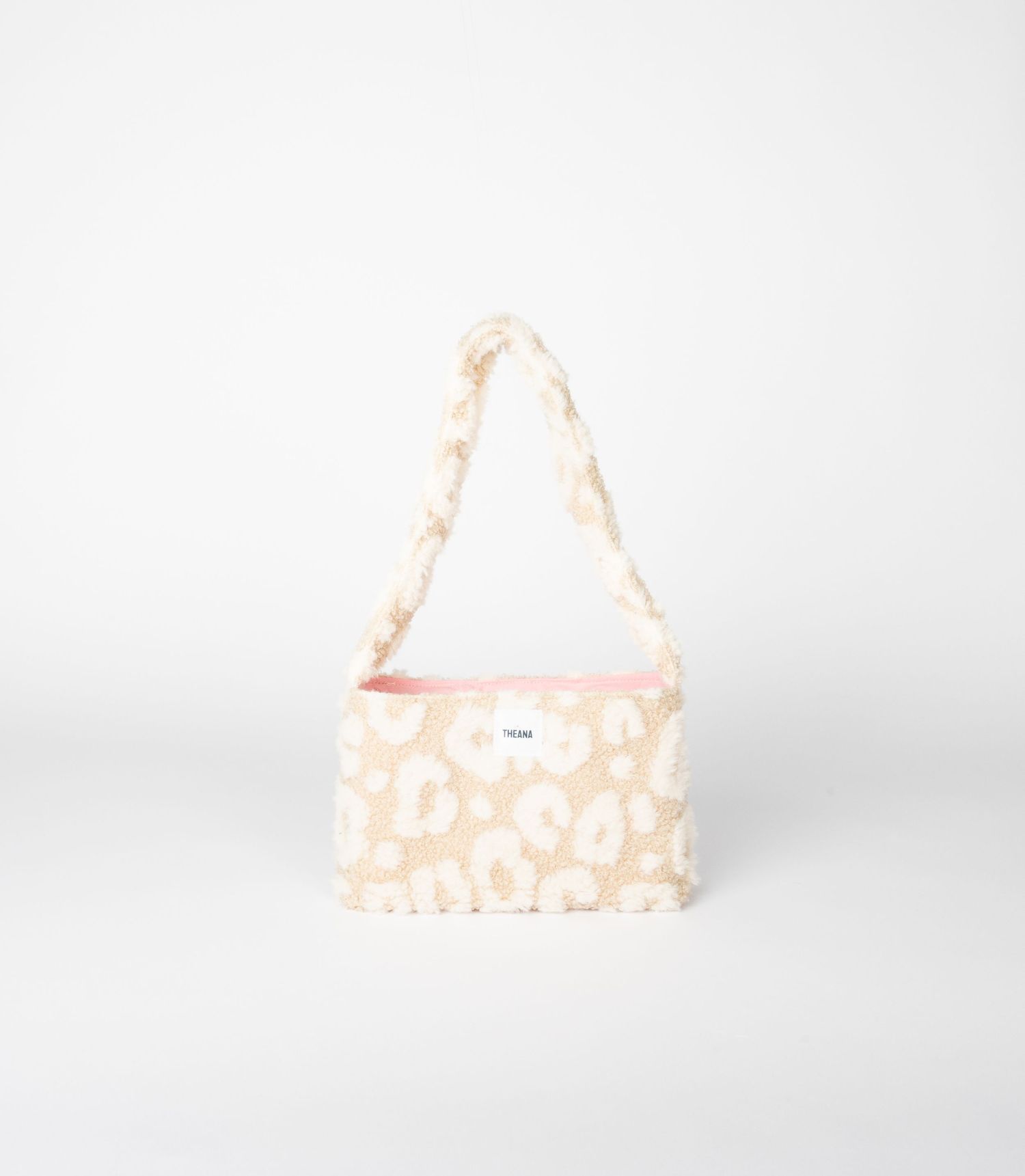 Cream leopard print fluffy sherpa shoulder bag with pink interior trim and textured strap, small brand label.