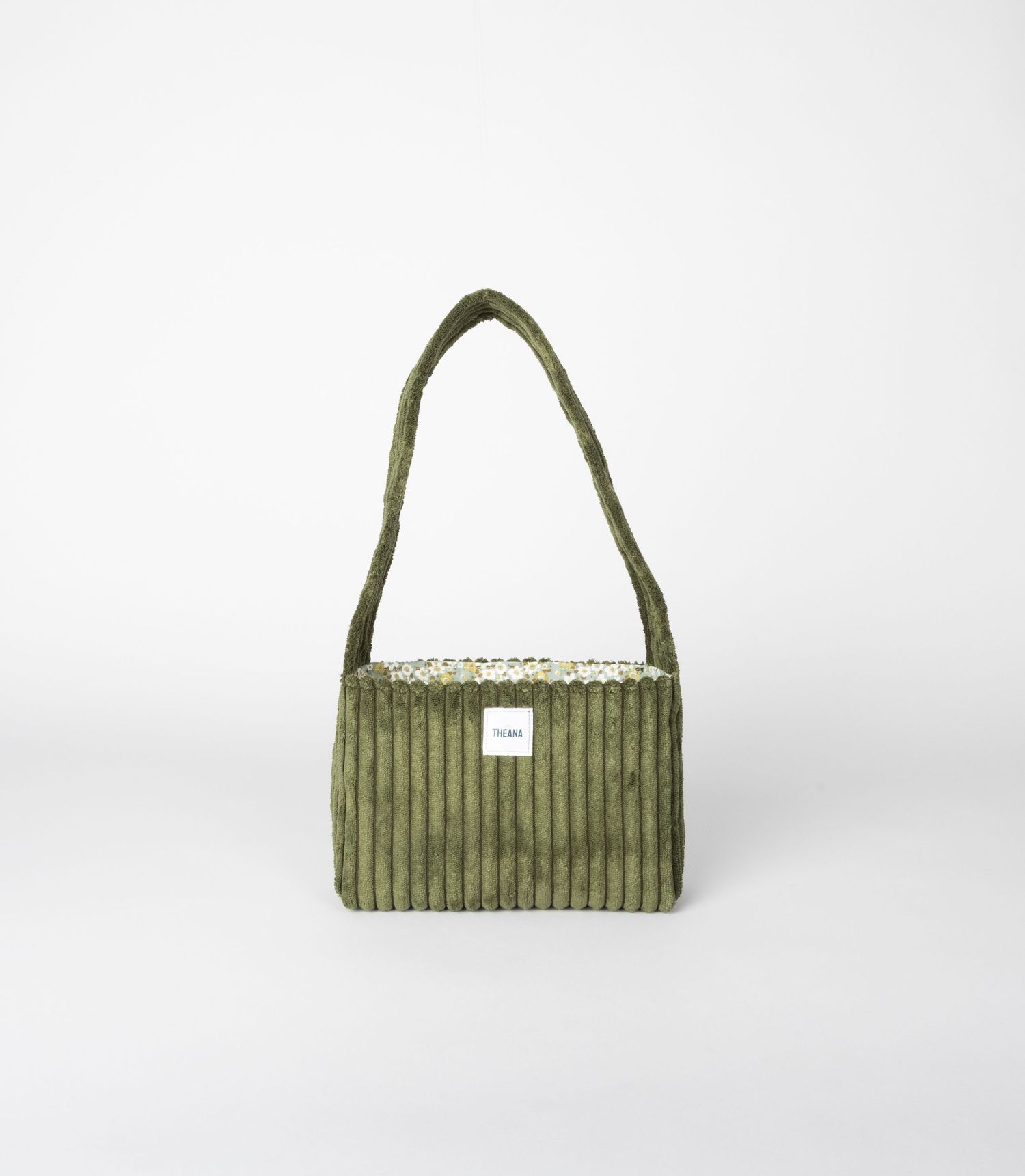 Olive green corduroy shoulder bag with cream trim and white brand label.