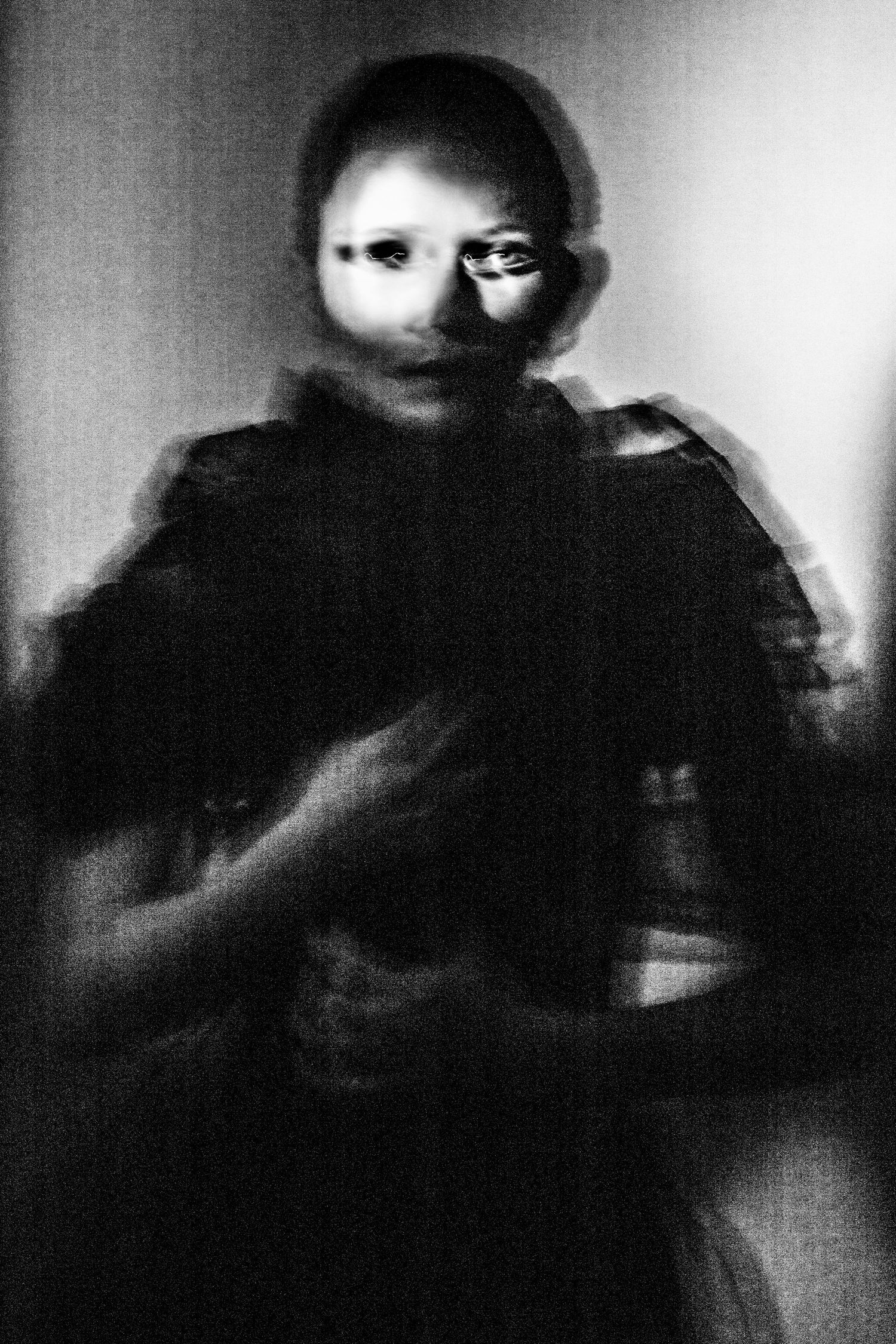 Abstract black and white blurred portrait of figure in dark clothing with motion effect.