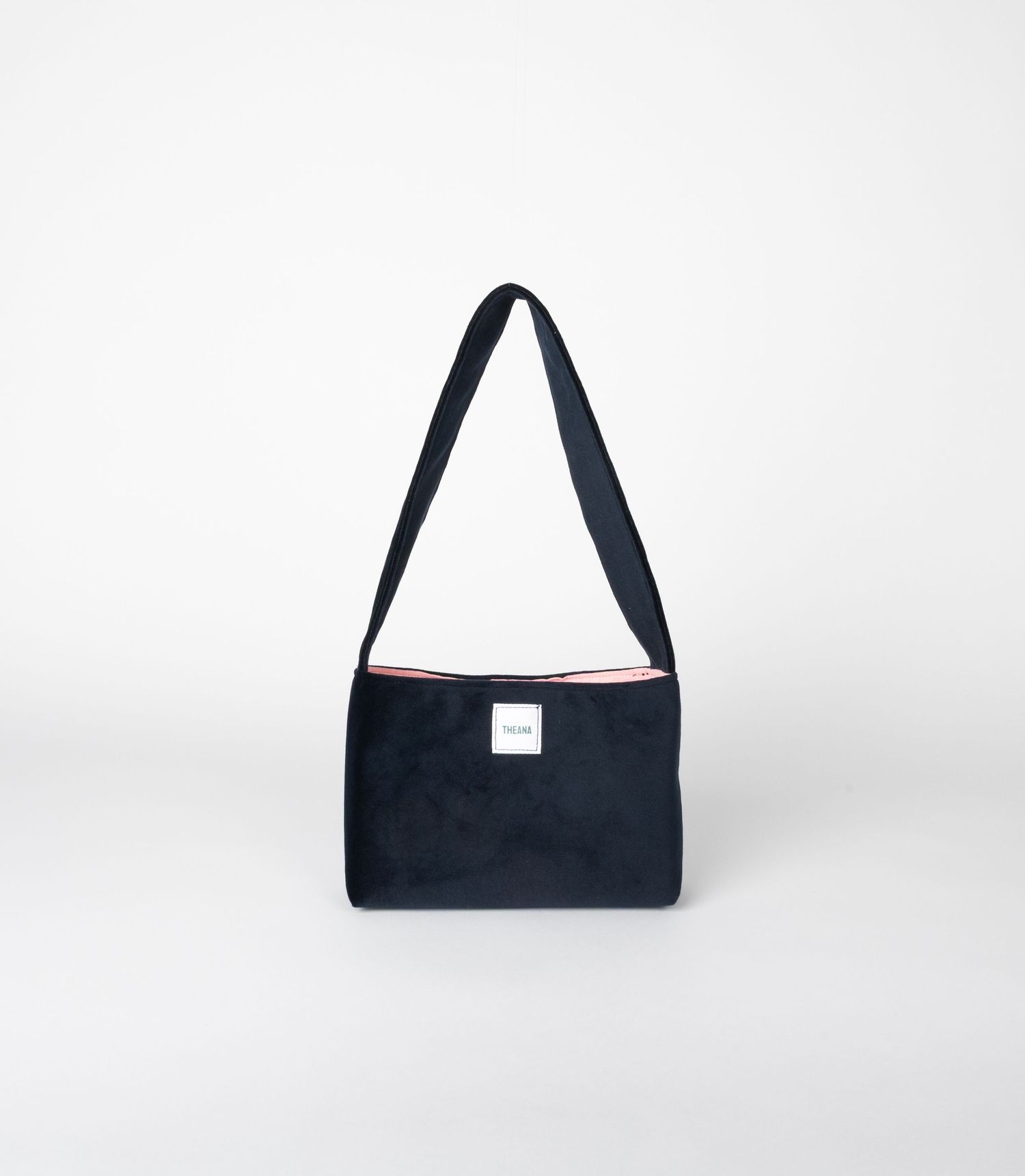 Navy blue shoulder bag with pink interior lining and white brand label.