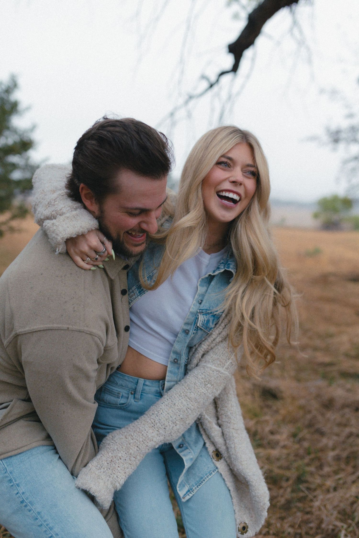 Lifestyle couples storytelling portrait in open field at sunset
