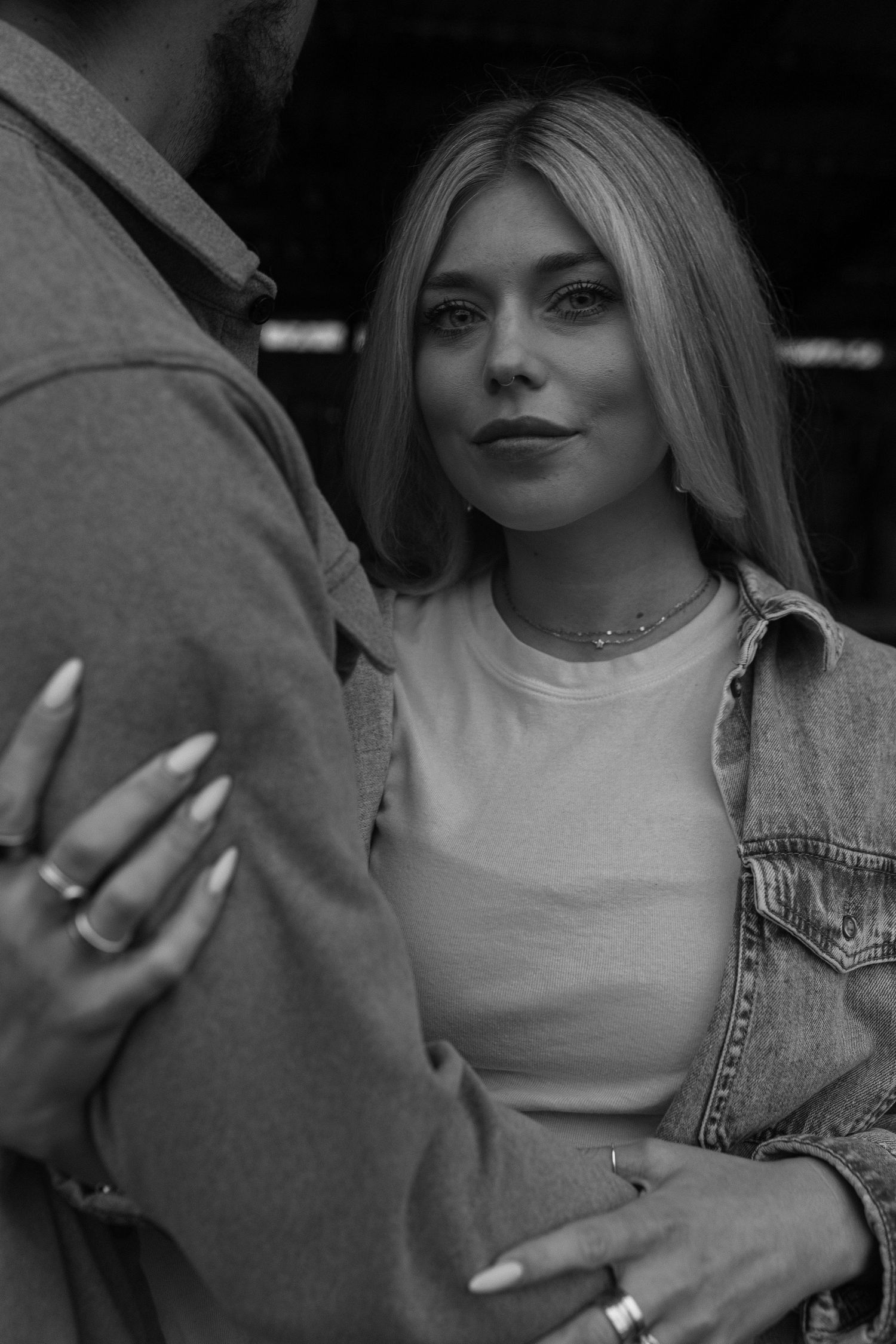 romantic black and white portrait of woman holding arm of her husband