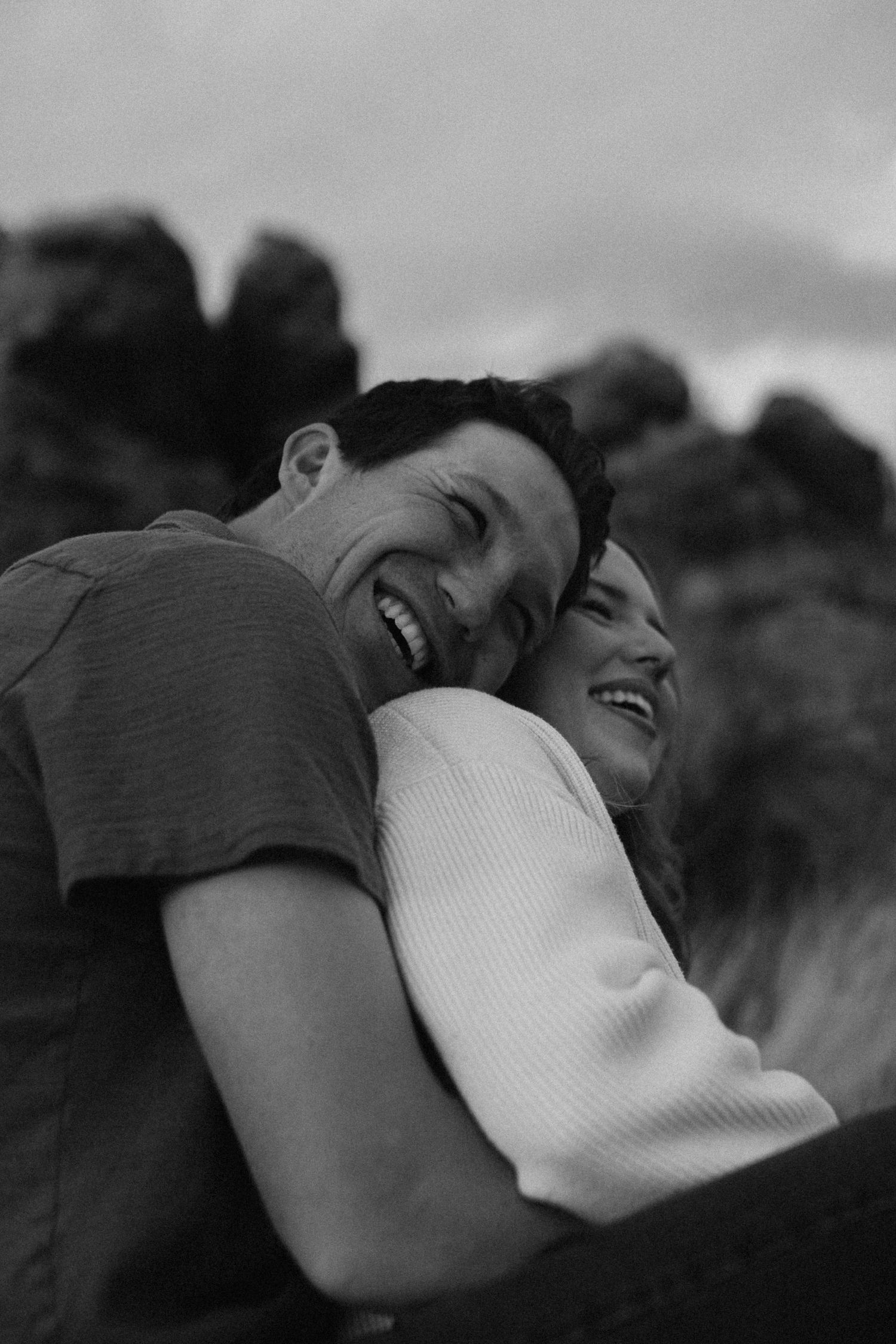 Young couple cuddling during backyard lifestyle session in fort collins colorado