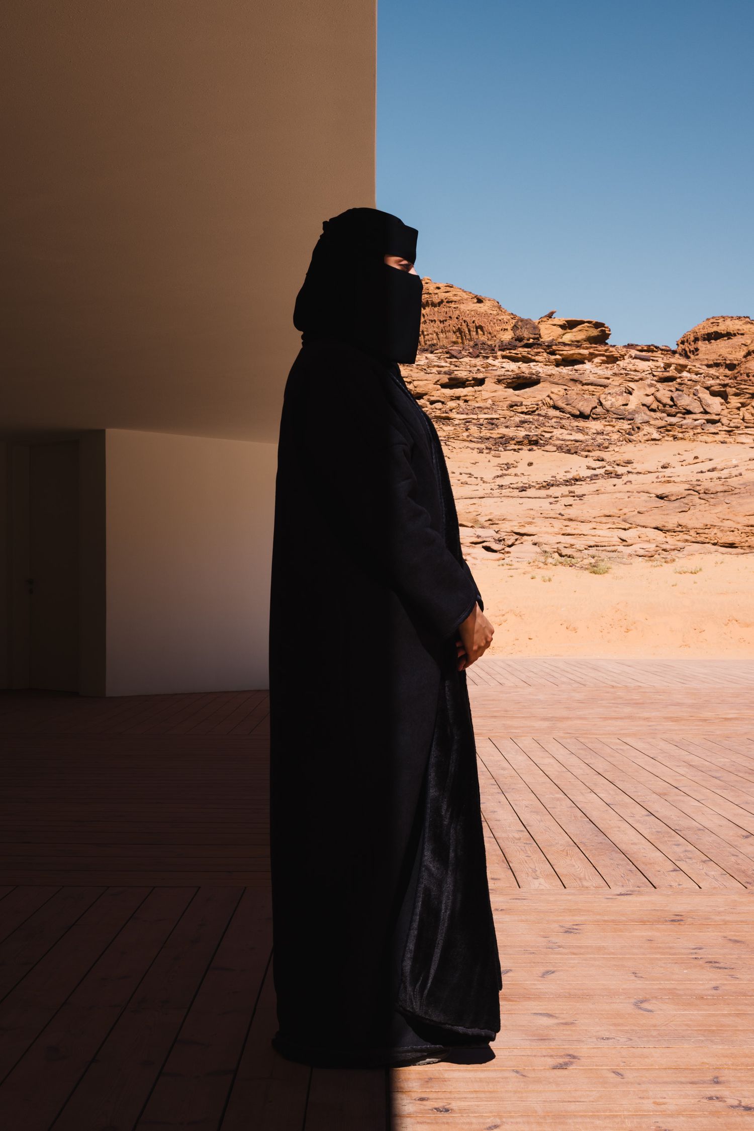 Silhouette of a woman standing to greet visitors at the Desert X AlUla 2024 visitor center in AlUla Saudi Arabia