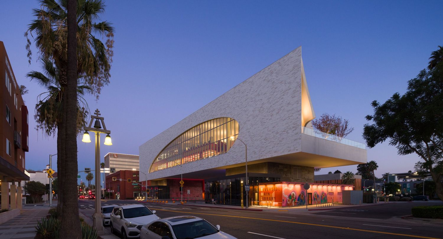 Panorama of the north west corner of Riverside Main Library from the street at dusk