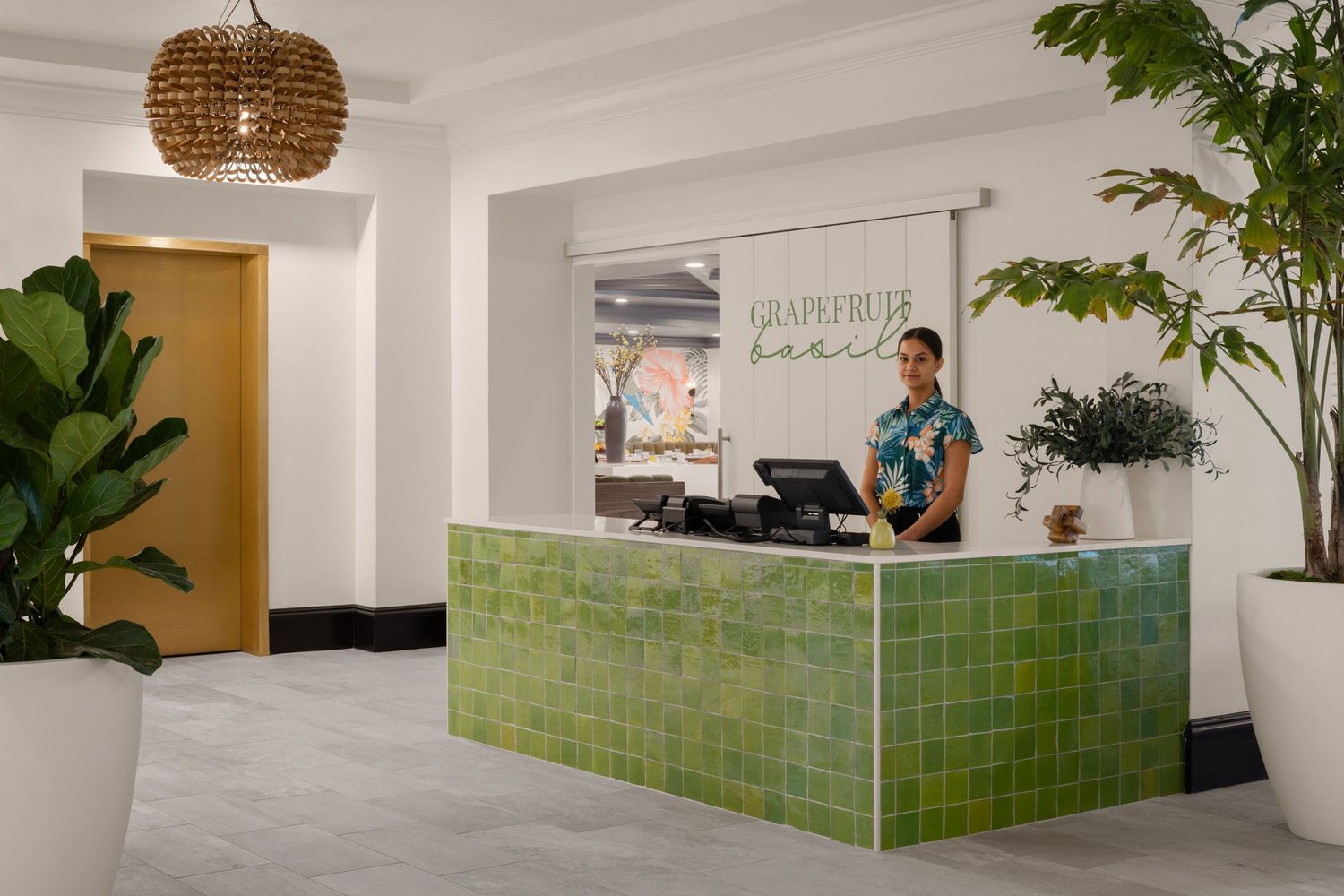 Host stand with hostess at Grapefruit Basil restaurant at Tommy Bahama Miramonte Resort