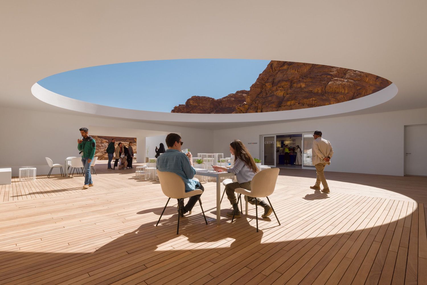 People dining in the open air at the 2022 Desert X Visitor Center in AlUla