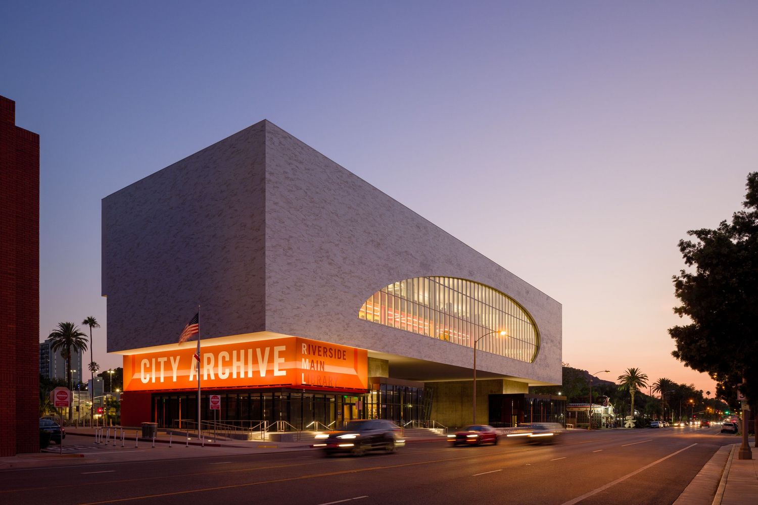 Riverside Main Library from the street at dusk by Johnson Favaro