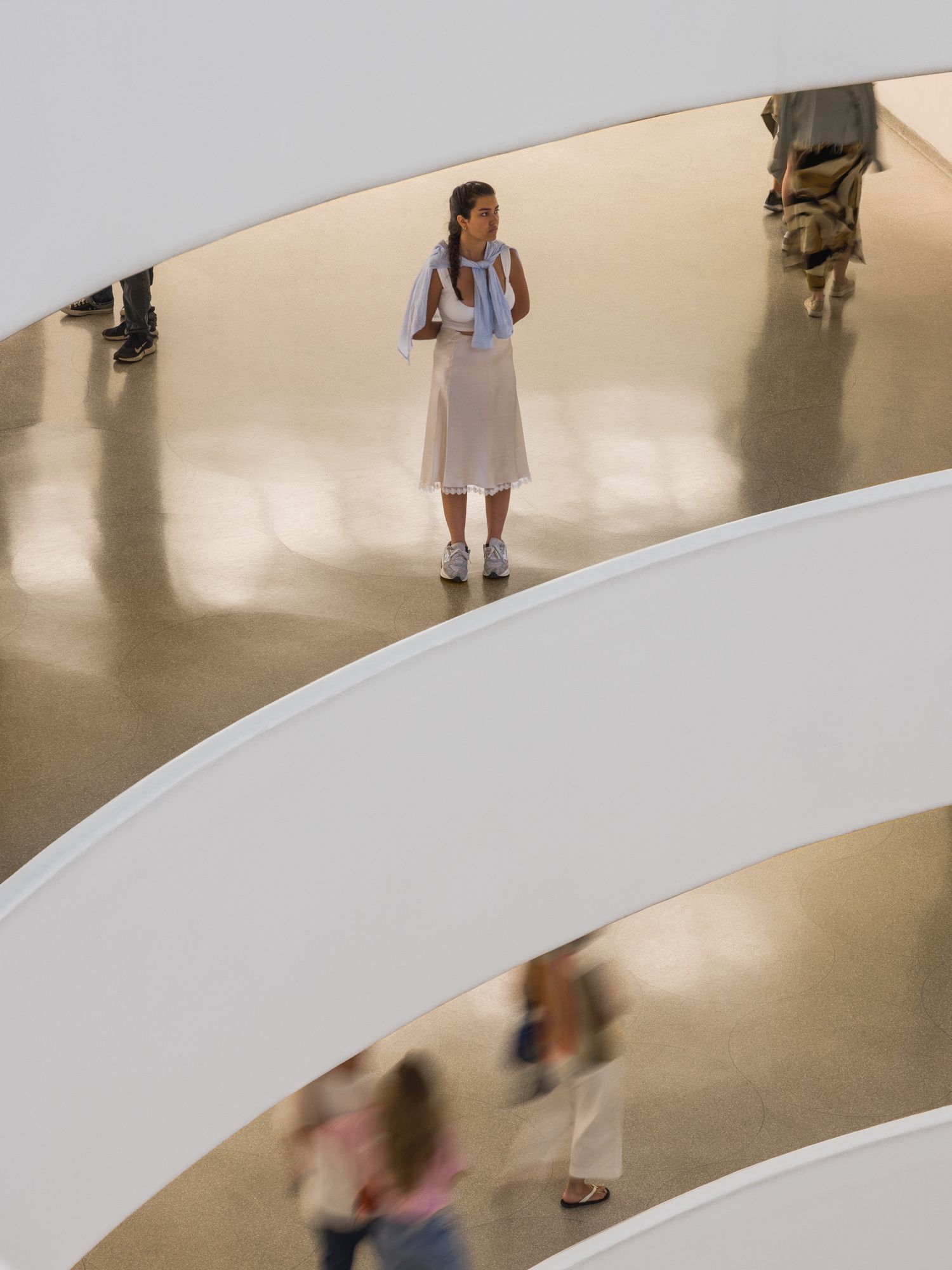 A woman observing the space of the Guggenheim, Frank Lloyd Wright, in New York City