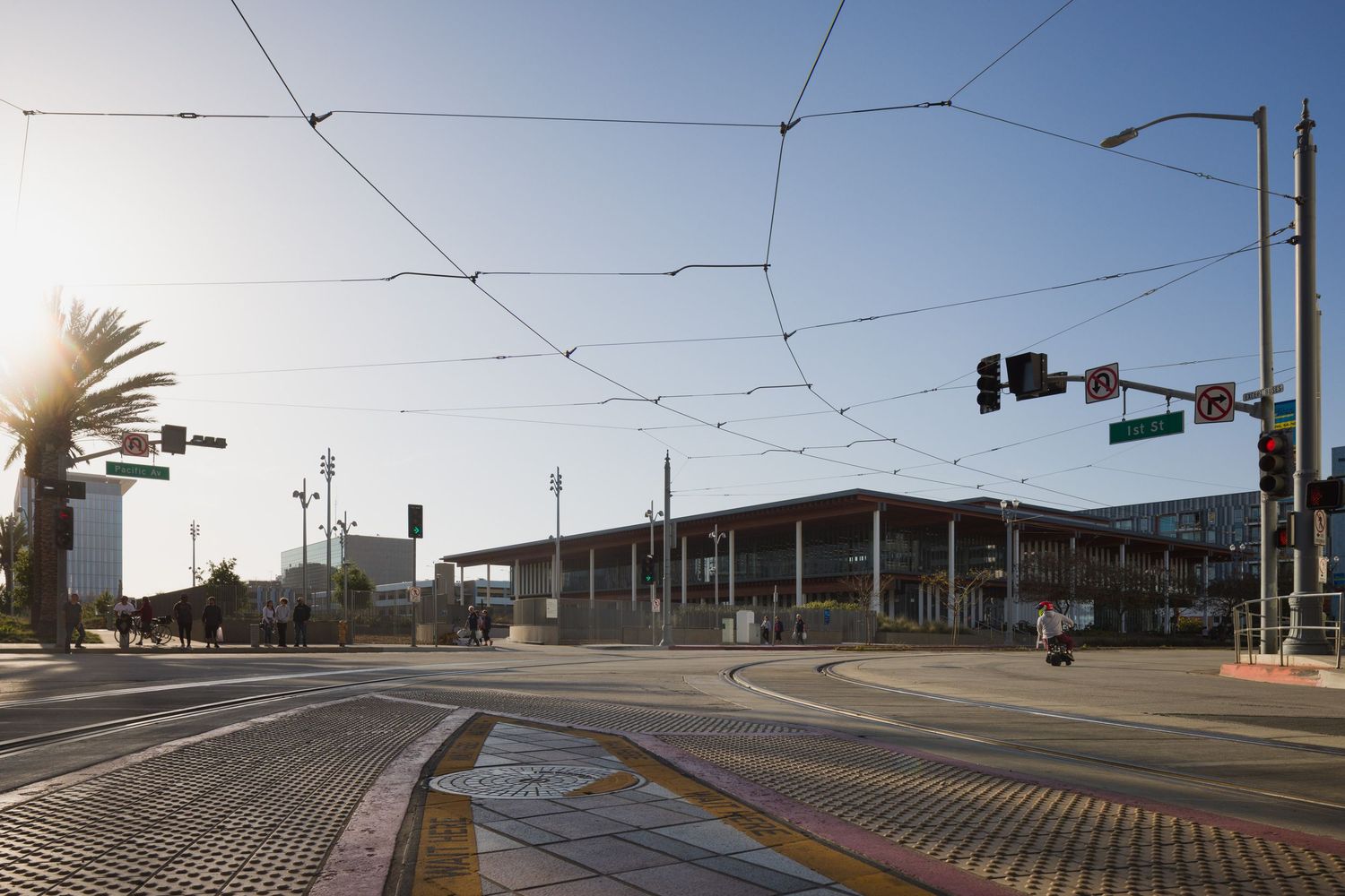 The Billie Jean King Main Library in Long Beach California with electric bus lines framing the building