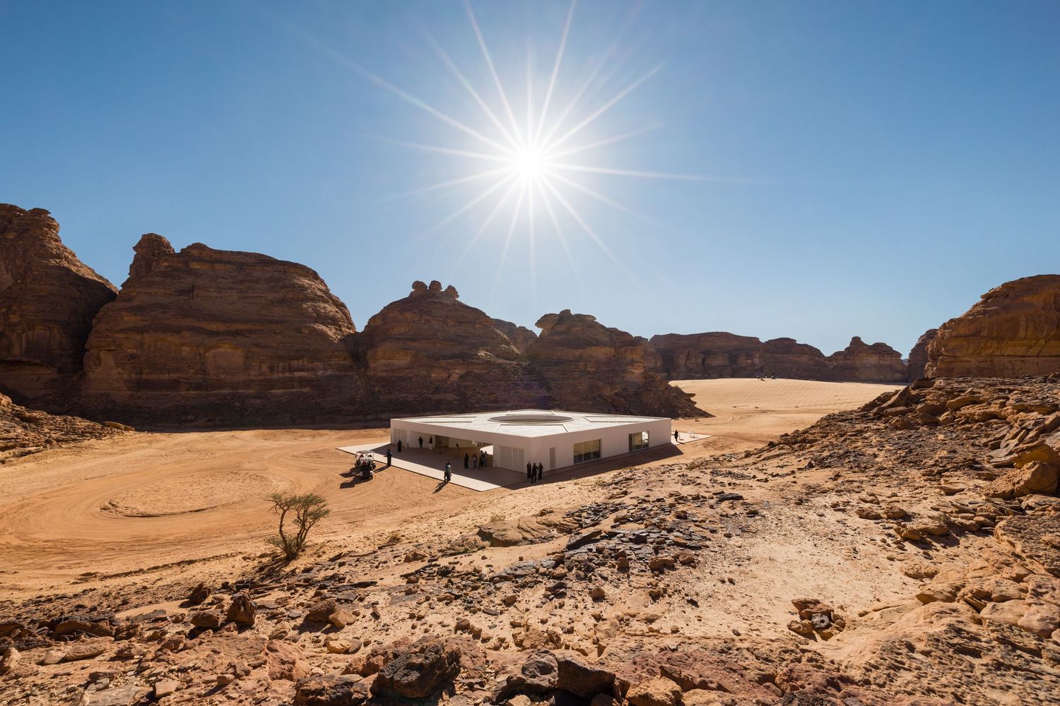 Wide angle view of Desert X AlUla 2024 visitor center by KWY.studio showing building in the surrounding landscape