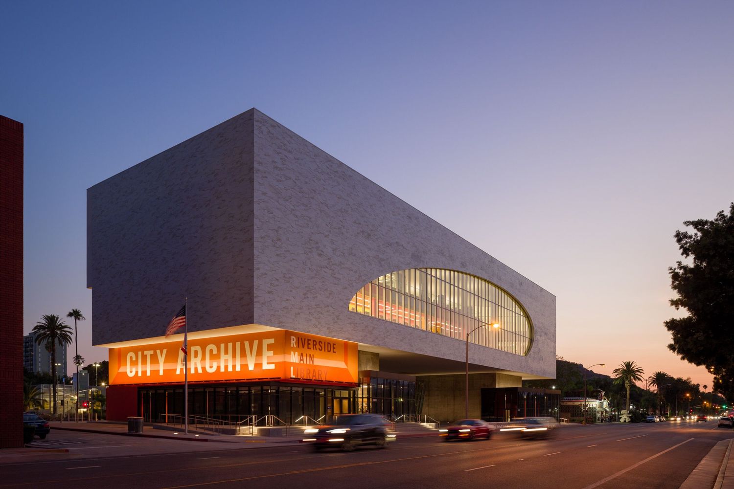 Riverside Main Library from the street at dusk by Johnson Favaro