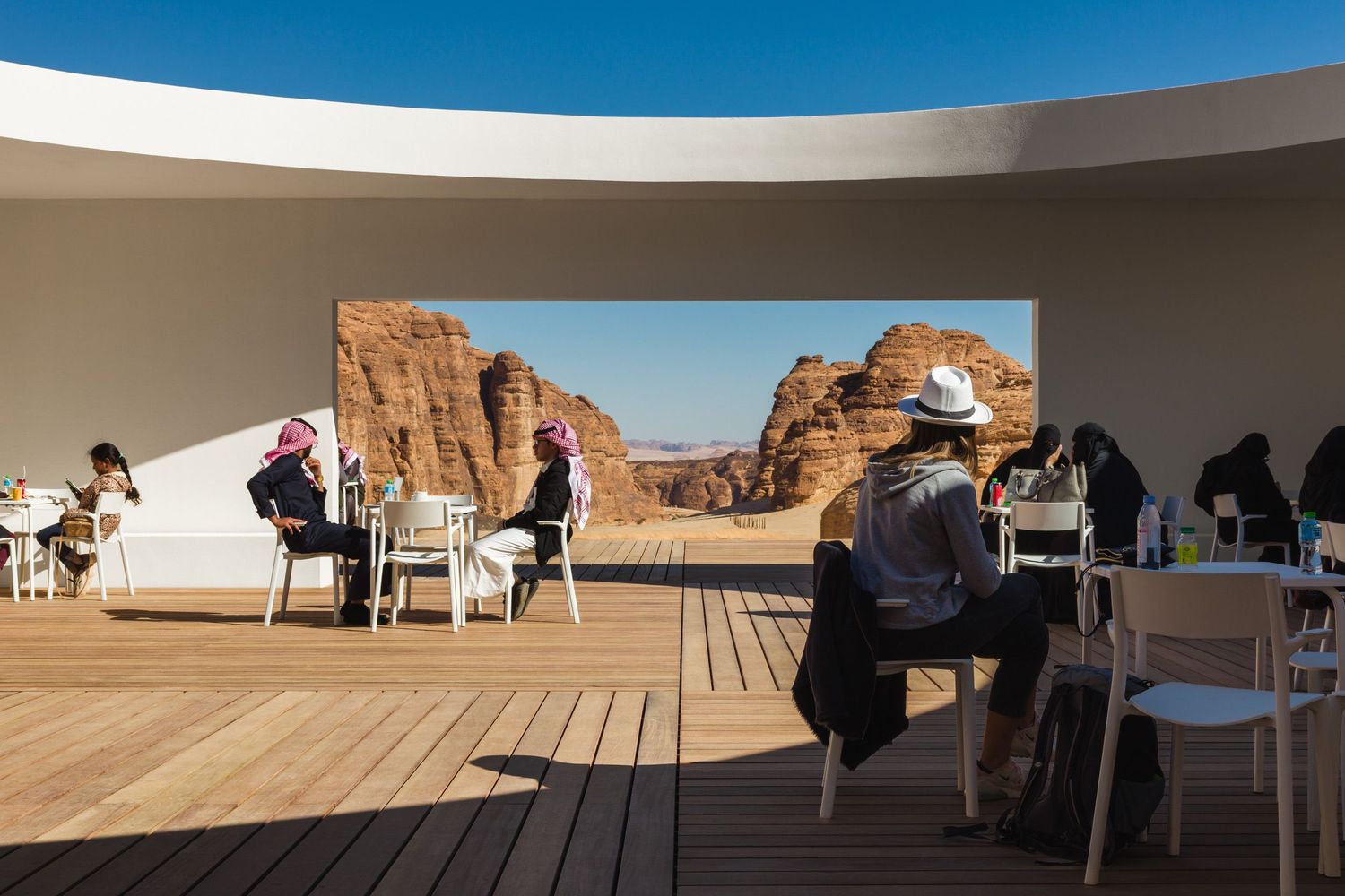 People looking out at the surrounding landscape and artwork from the at visitor center by KWY.studio at Desert X AlUla 2020