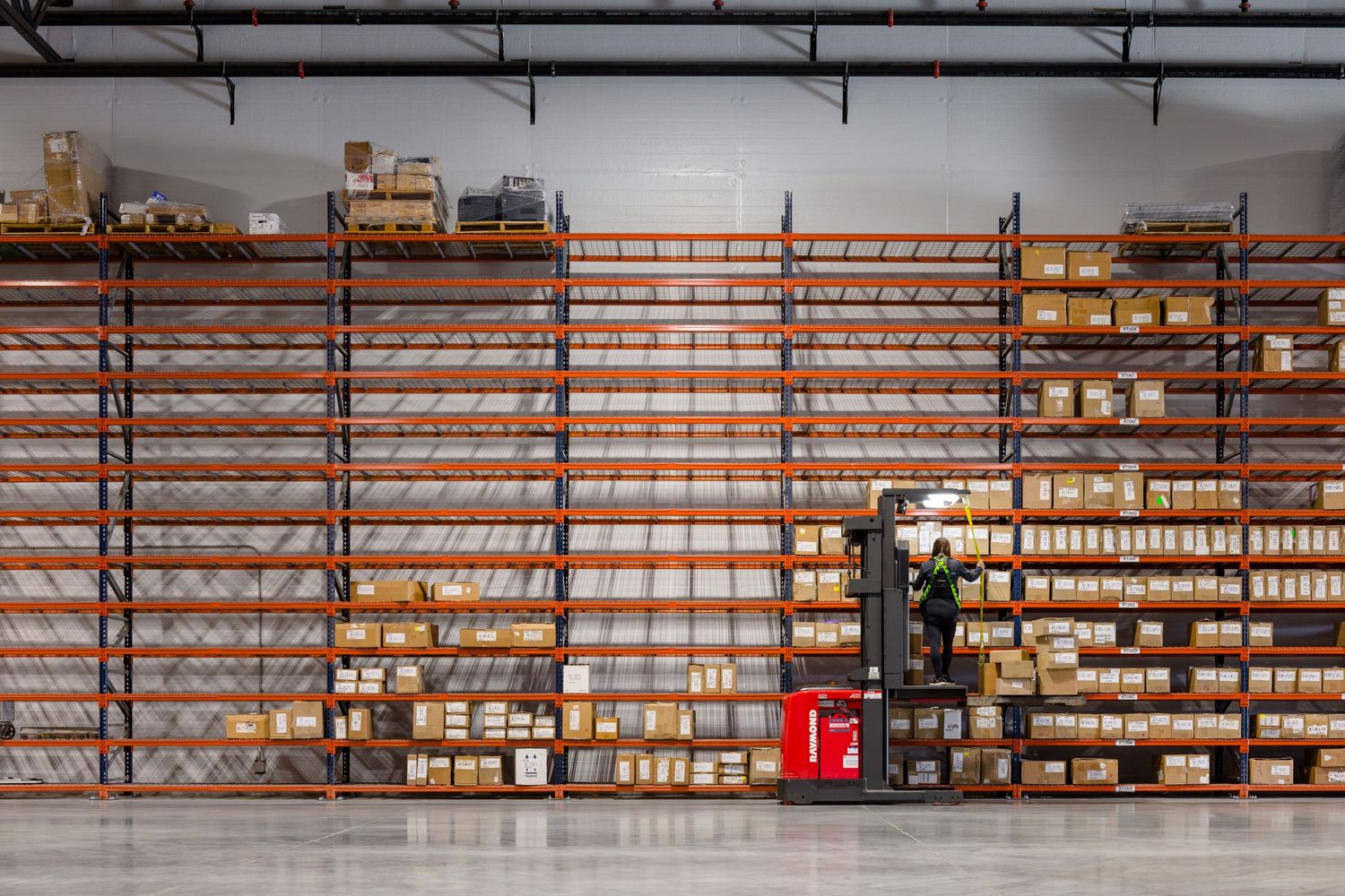 Woman stocking shelves at Copper Peak Logistics warehouse by ARCO/Murray design build