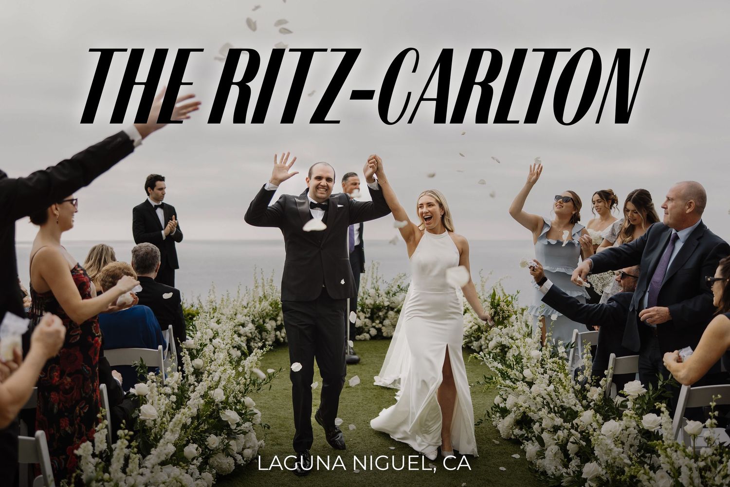 A joyous wedding ceremony celebration at The Ritz-Carlton Laguna Niguel with guests surrounded by lush greenery.