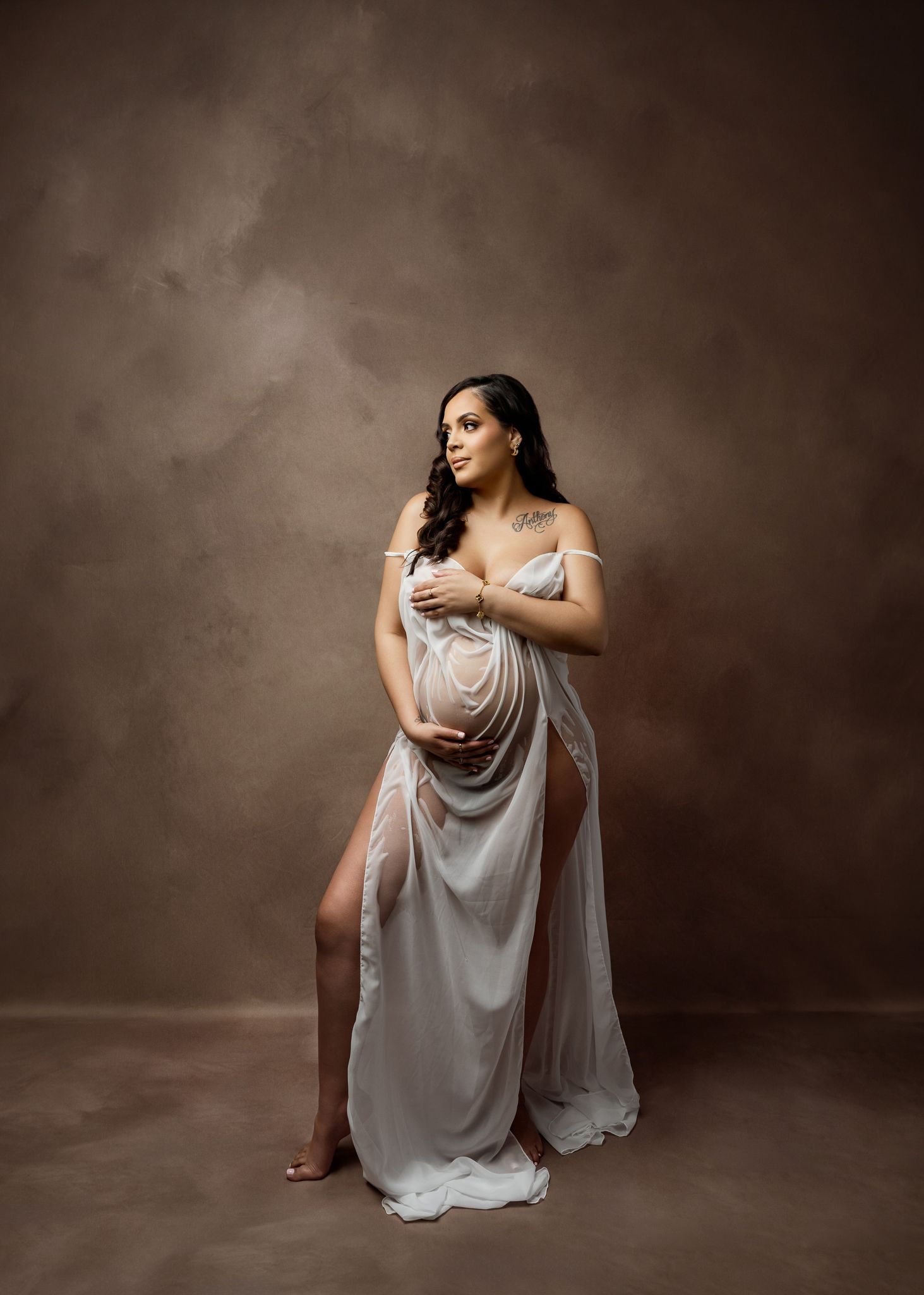 A figure in a flowing white dress poses gracefully in a series of artistic studio portraits with dark backdrop.