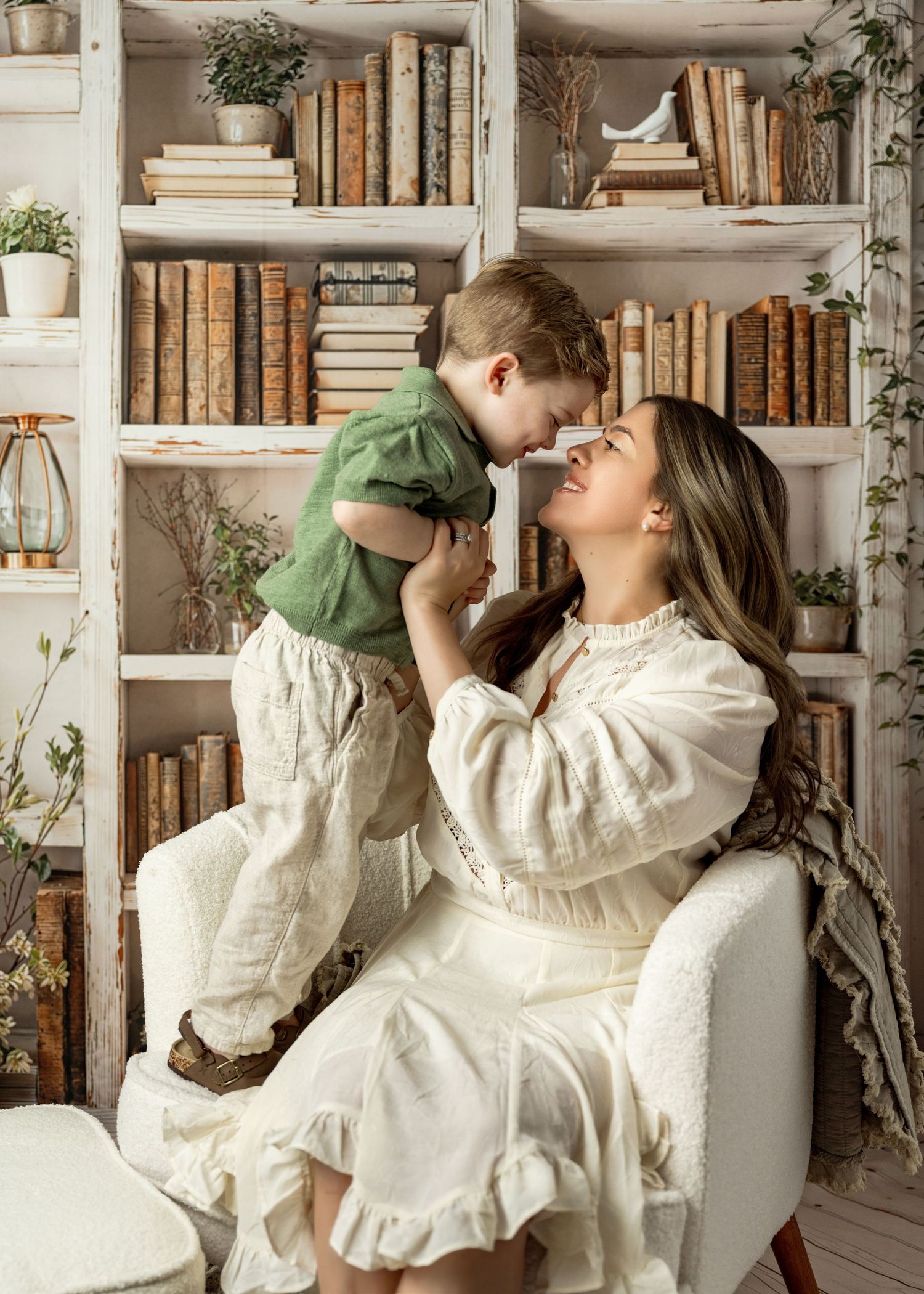 A cozy library scene with white bookshelves filled with antique books and decorative plants creating a vintage atmosphere.