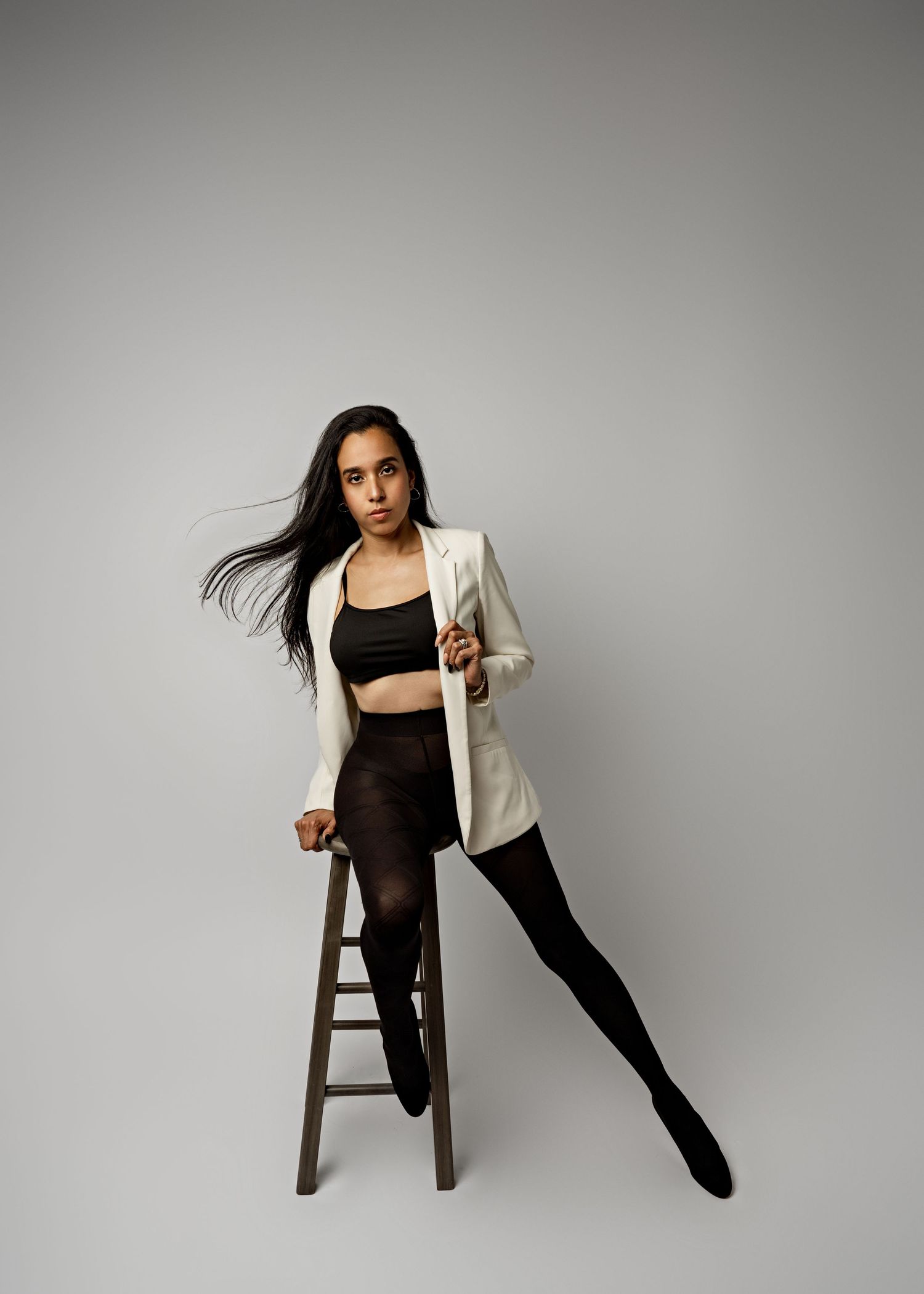 A dynamic sequence of dance movements shown in five progressive poses against a gray studio backdrop.