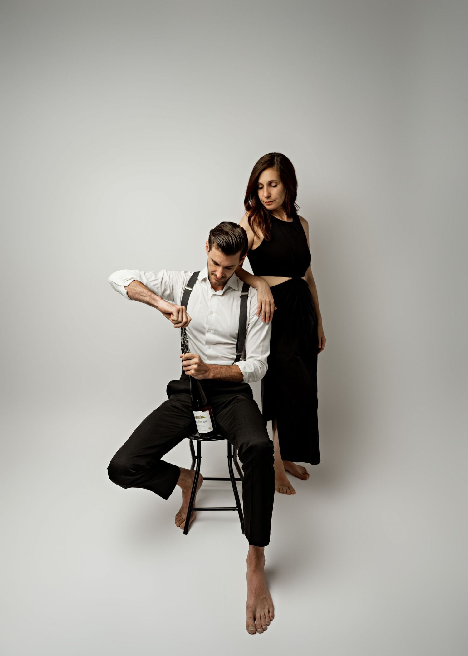 A graceful figure performs a series of expressive dance movements against a light gray studio backdrop.
