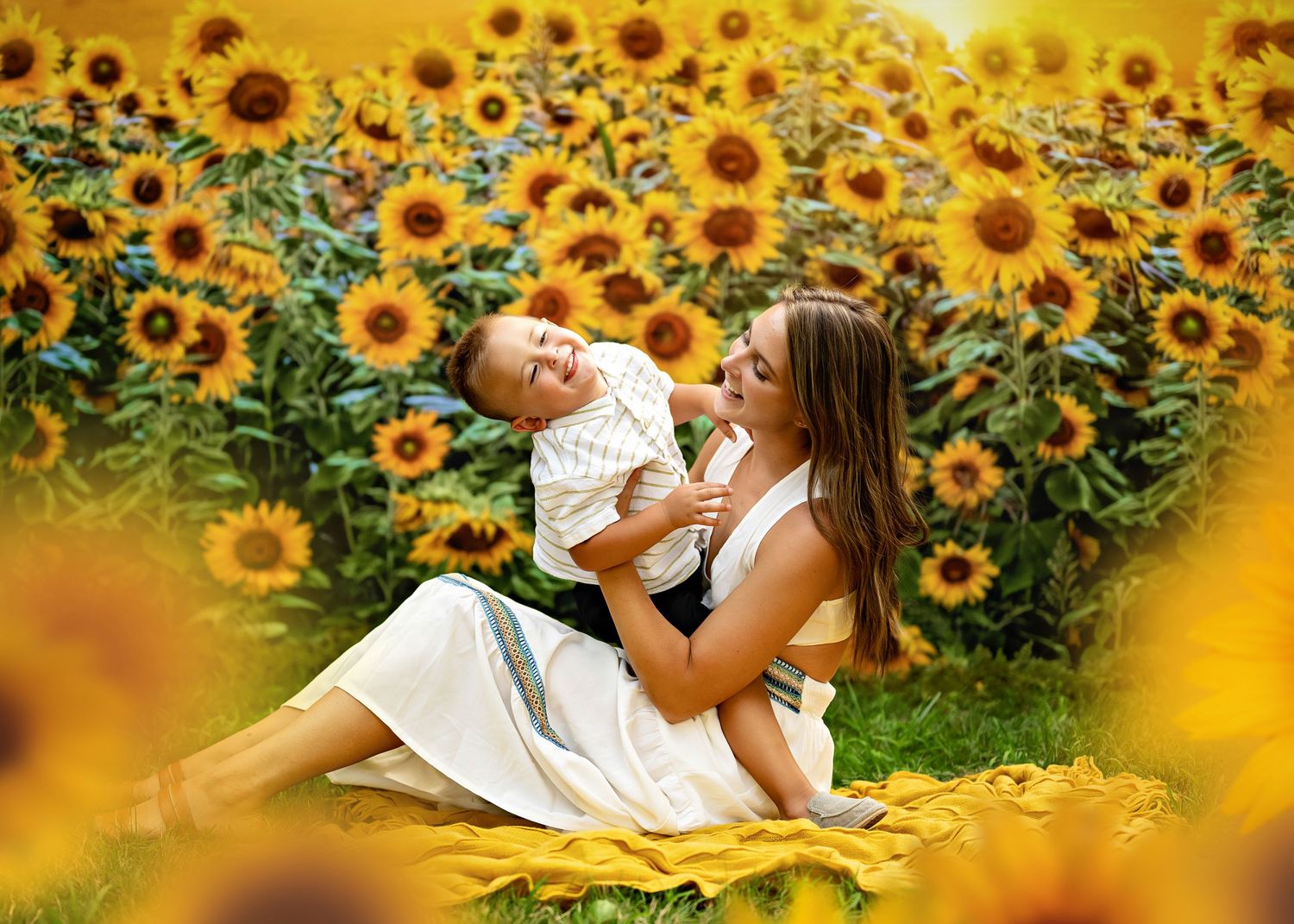 Beautiful garden scene with someone wearing white sitting among blooming yellow sunflowers in summer.