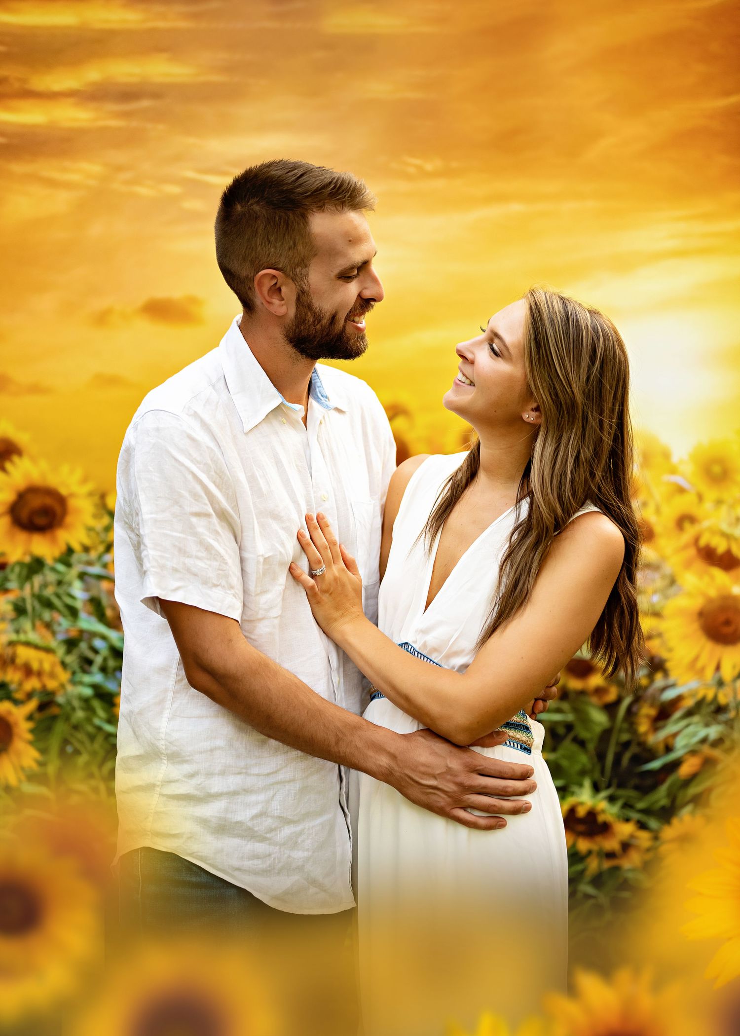 Couple embraces and shares loving moment in stunning sunflower field at sunset with golden sky.