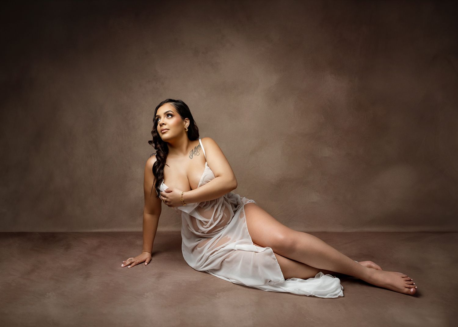 A series of artistic boudoir photos showing a figure in draped fabric posing gracefully against a dark background.