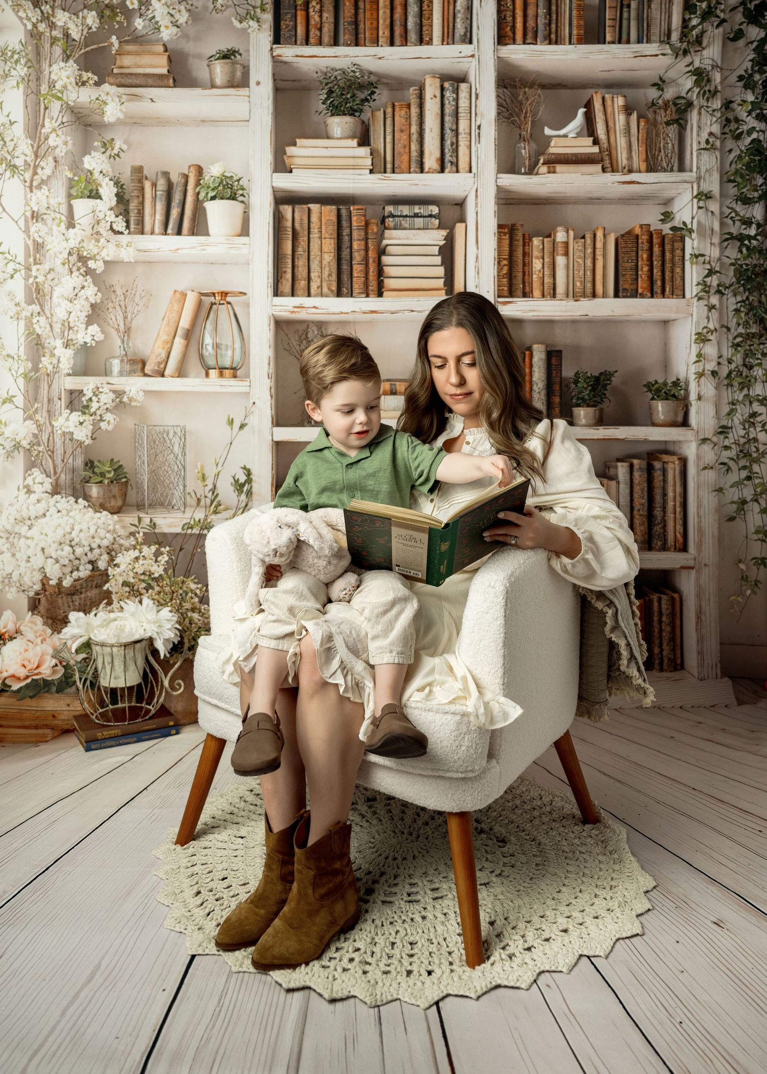 A cozy reading nook features a white armchair against built-in bookshelves with potted plants and vintage books.
