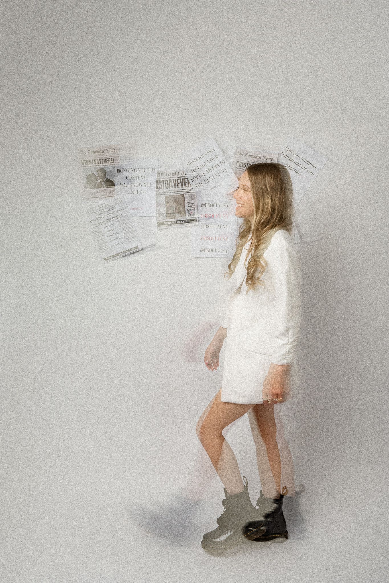 A figure in a white outfit and boots stands against a light background with blurred newspaper pages floating behind them.