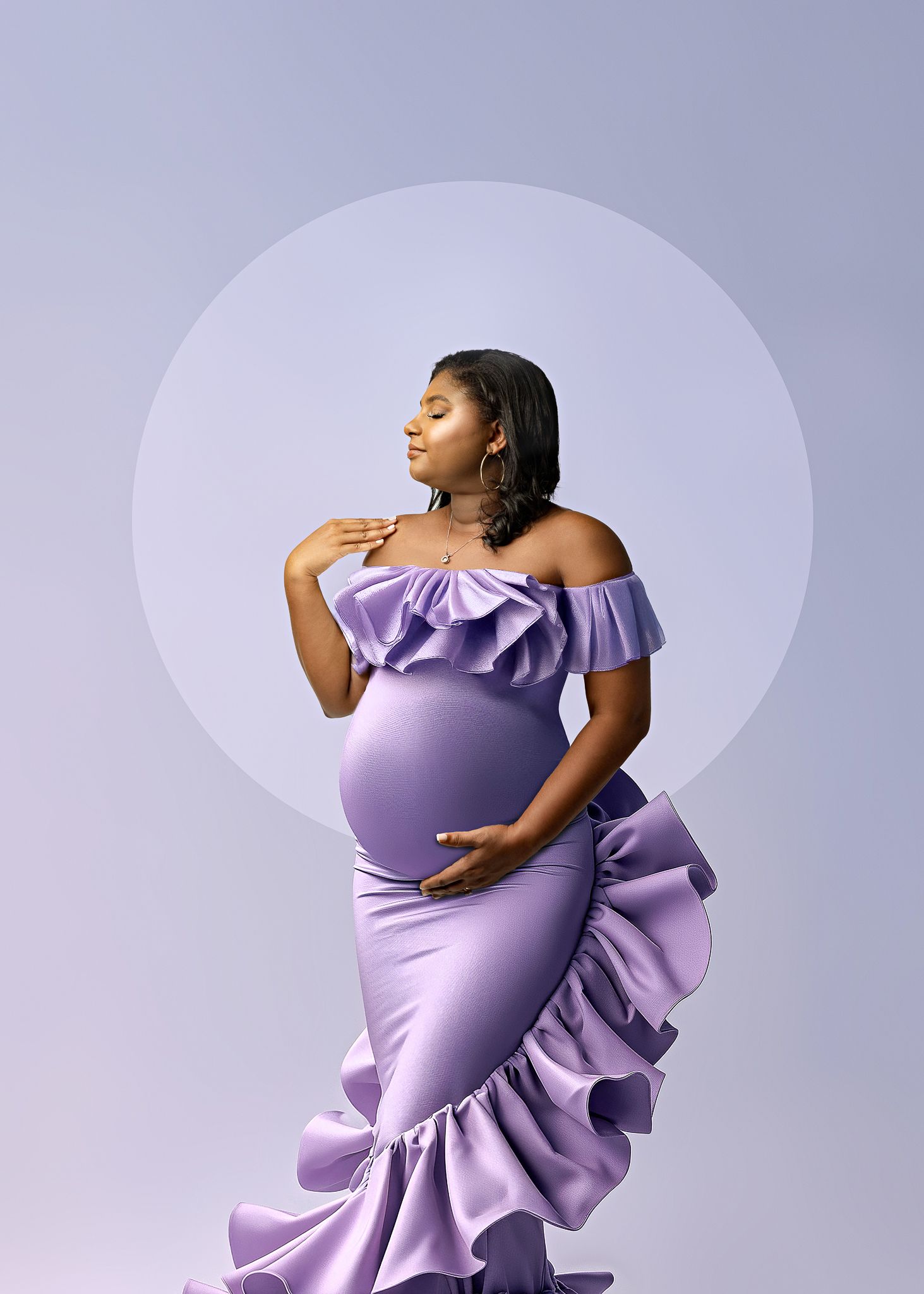 Maternity photo of a graceful figure in a lavender ruffle dress against a soft purple circular backdrop.