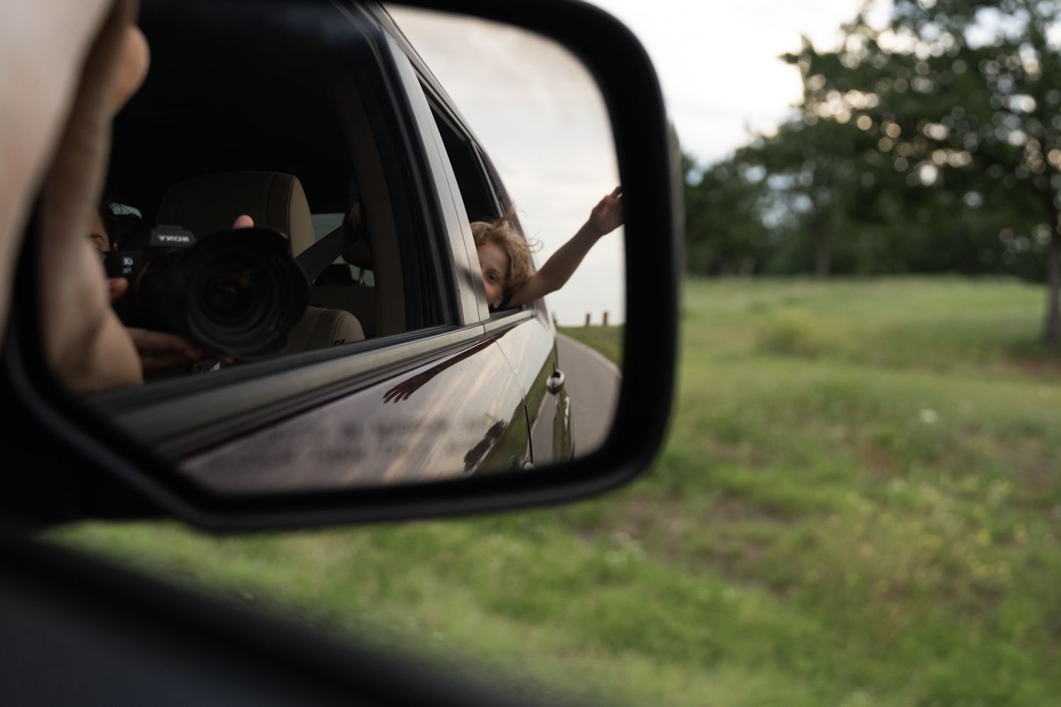 Tulsa Photographer captures herself and son in car mirror.