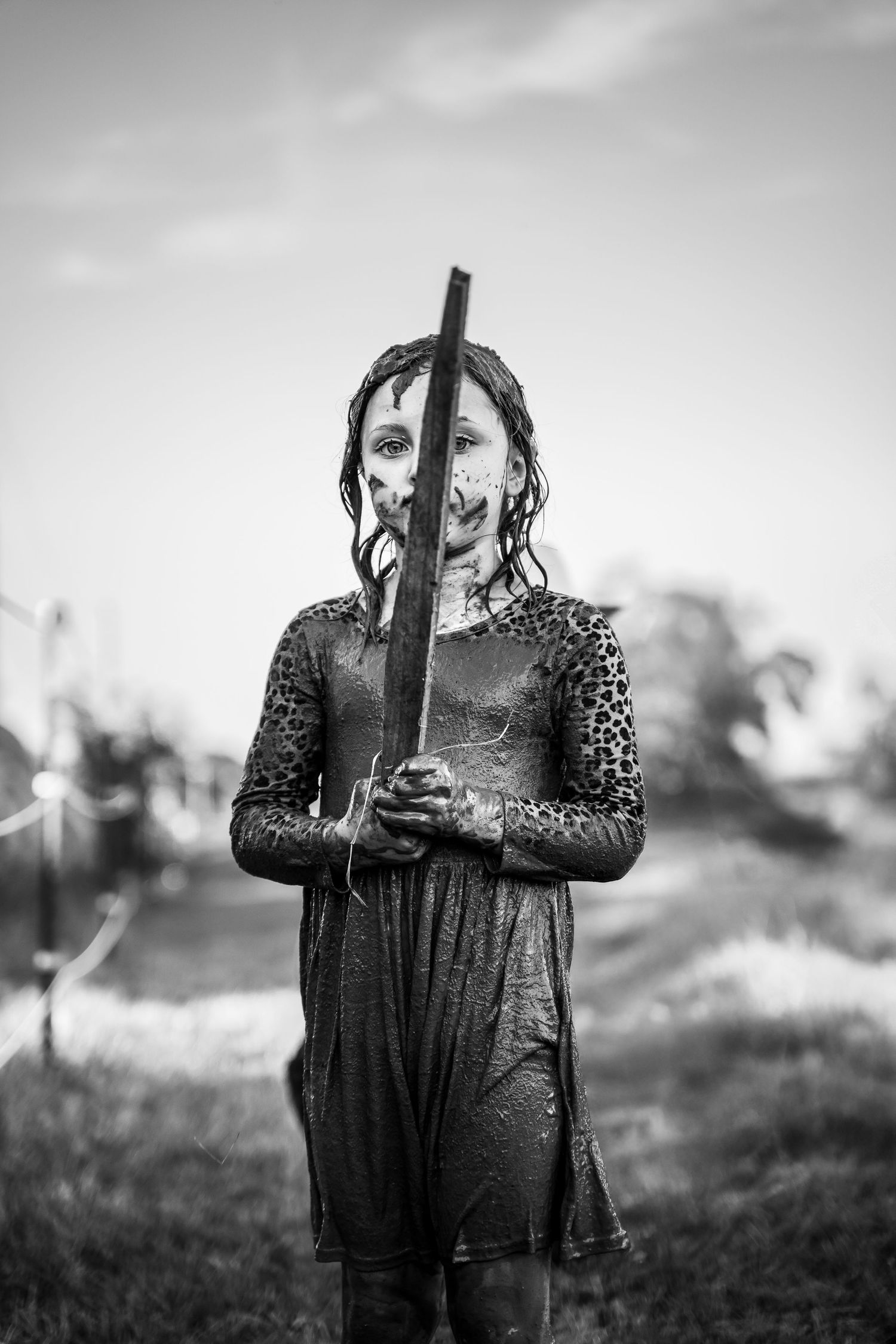 Tulsa Photographer captures muddy child with a stick sword in a family documentary photography session