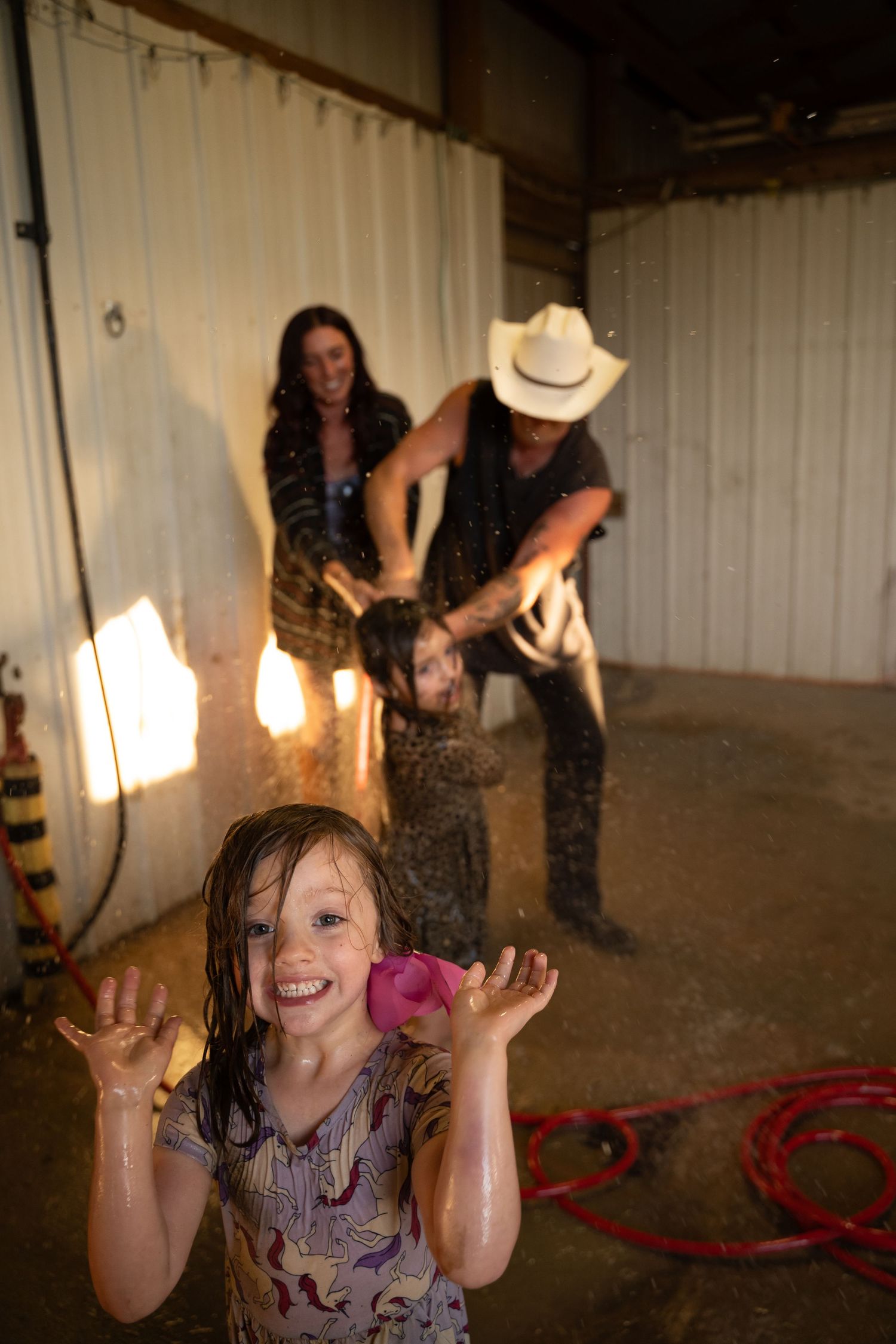 Tulsa Family washes off muddy chaos from family documentary photography session