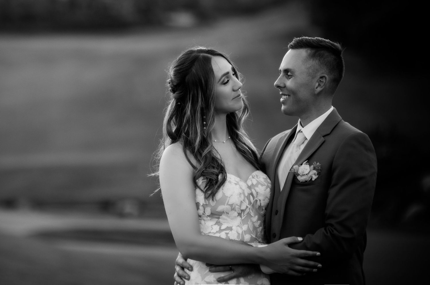 A romantic couple shares an intimate moment in black and white during their wedding photo session.