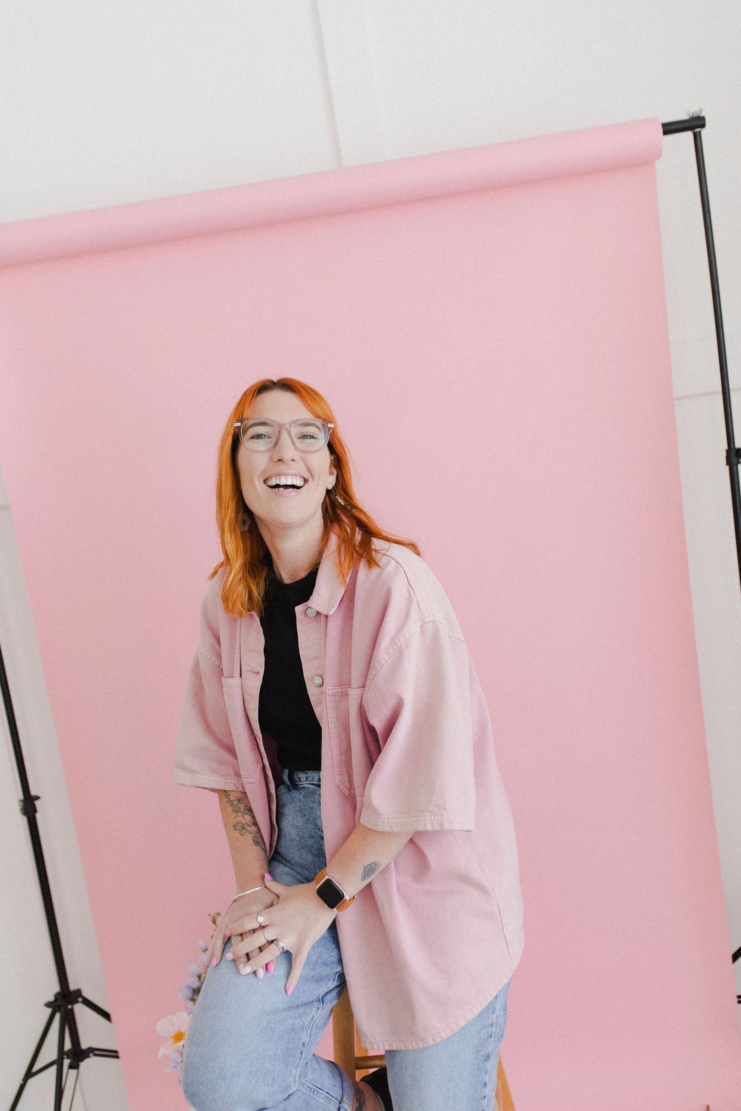 Female business owner laughing during relaxed branding photography session