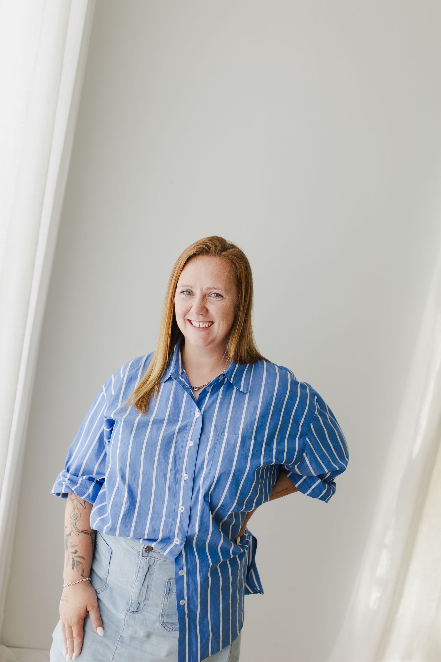 Female business owner smiling during headshot session in Hamilton studio