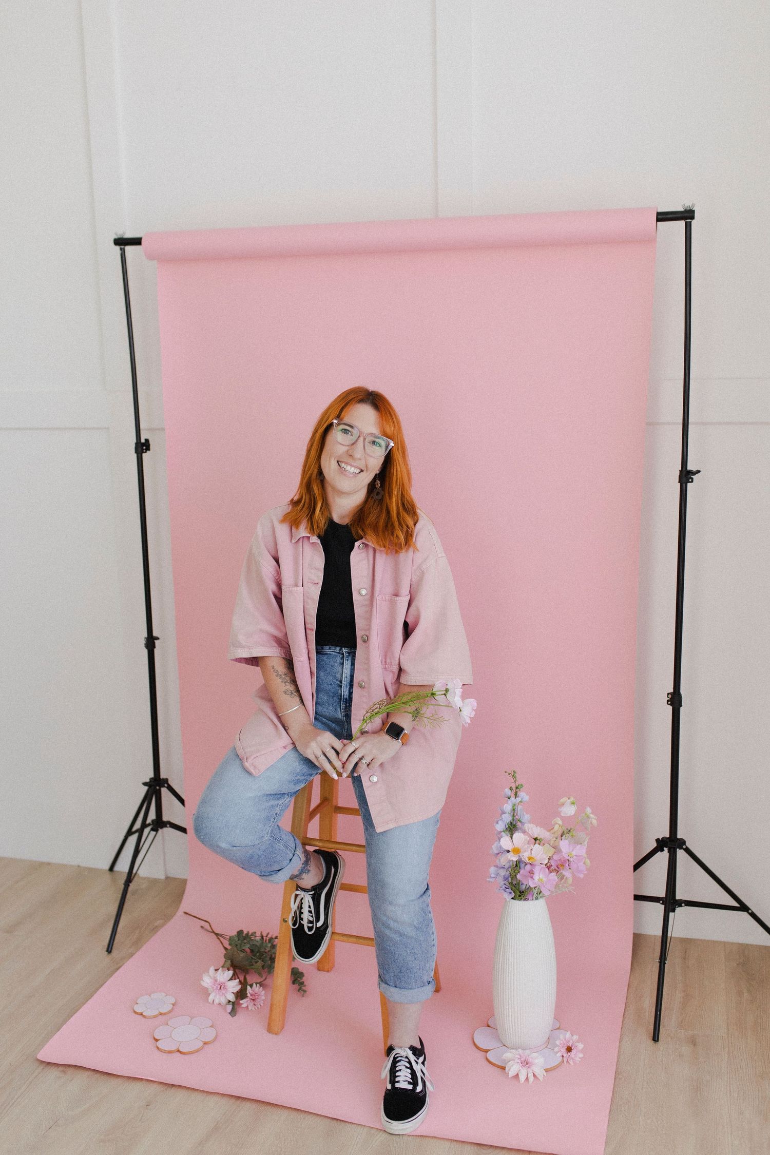 Woman sitting on stool during personal branding photoshoot in studio