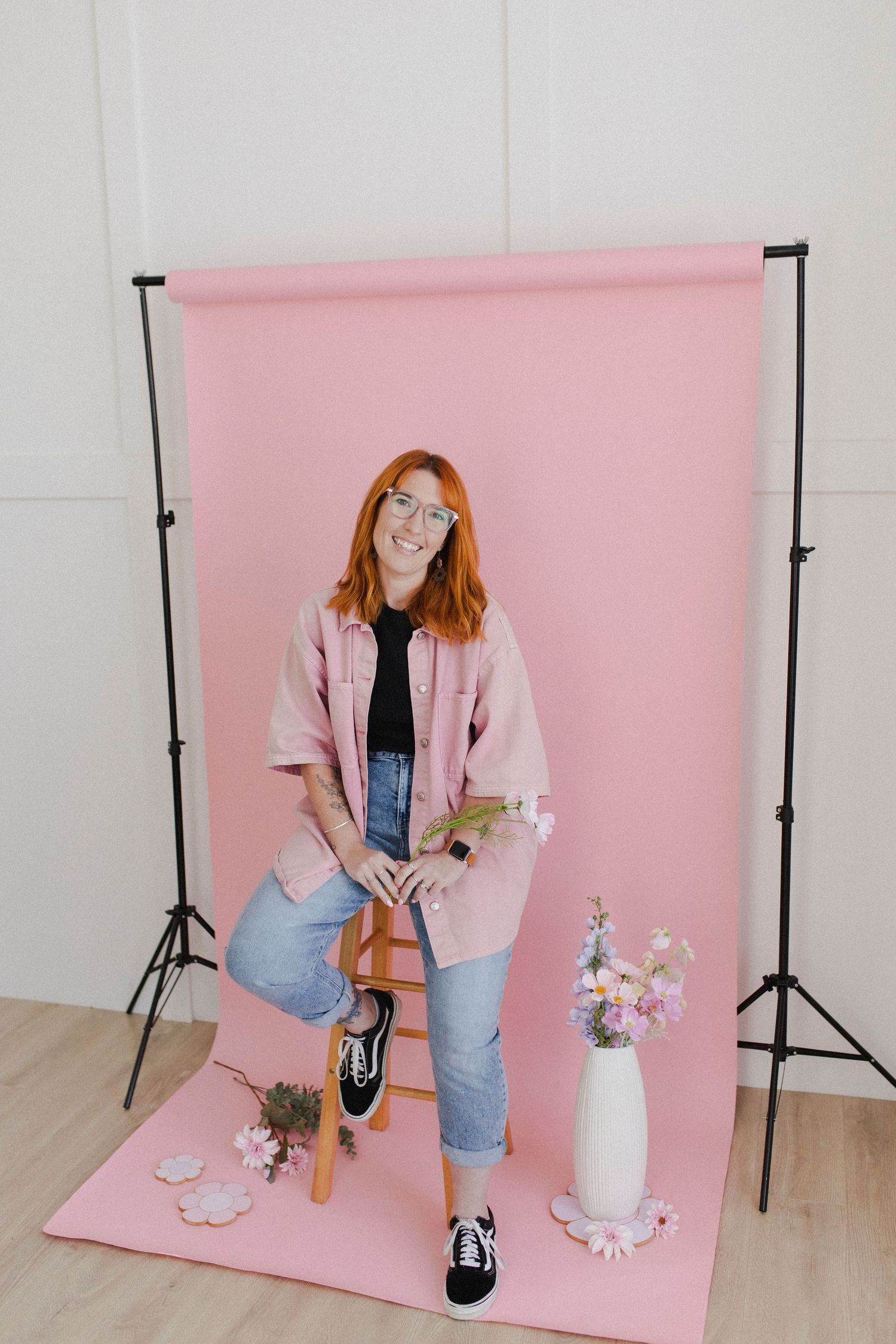 Woman sitting on stool during personal branding photoshoot in studio