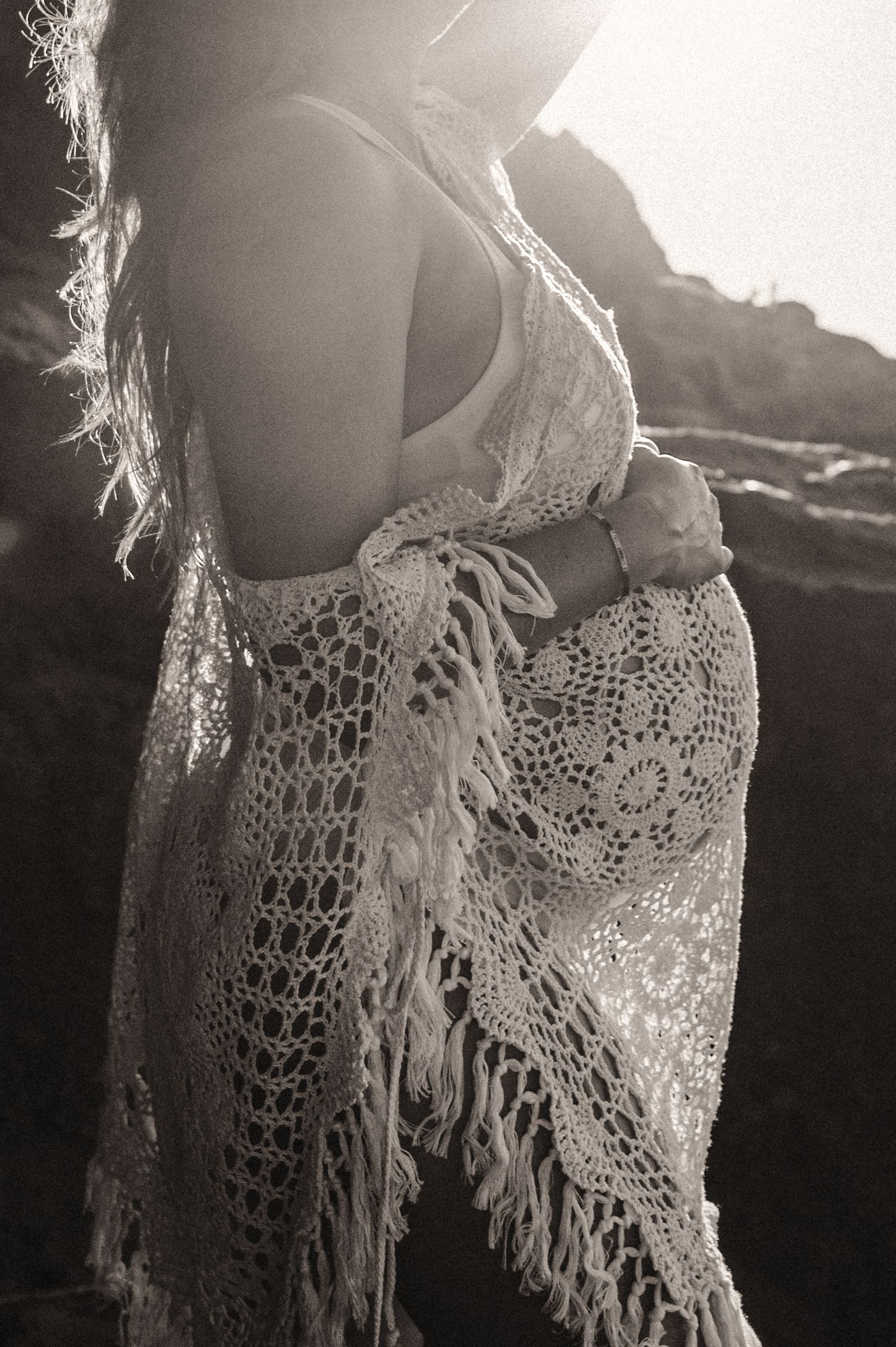A series of black and white photos showing delicate lace crochet details on a garment against a dark background.