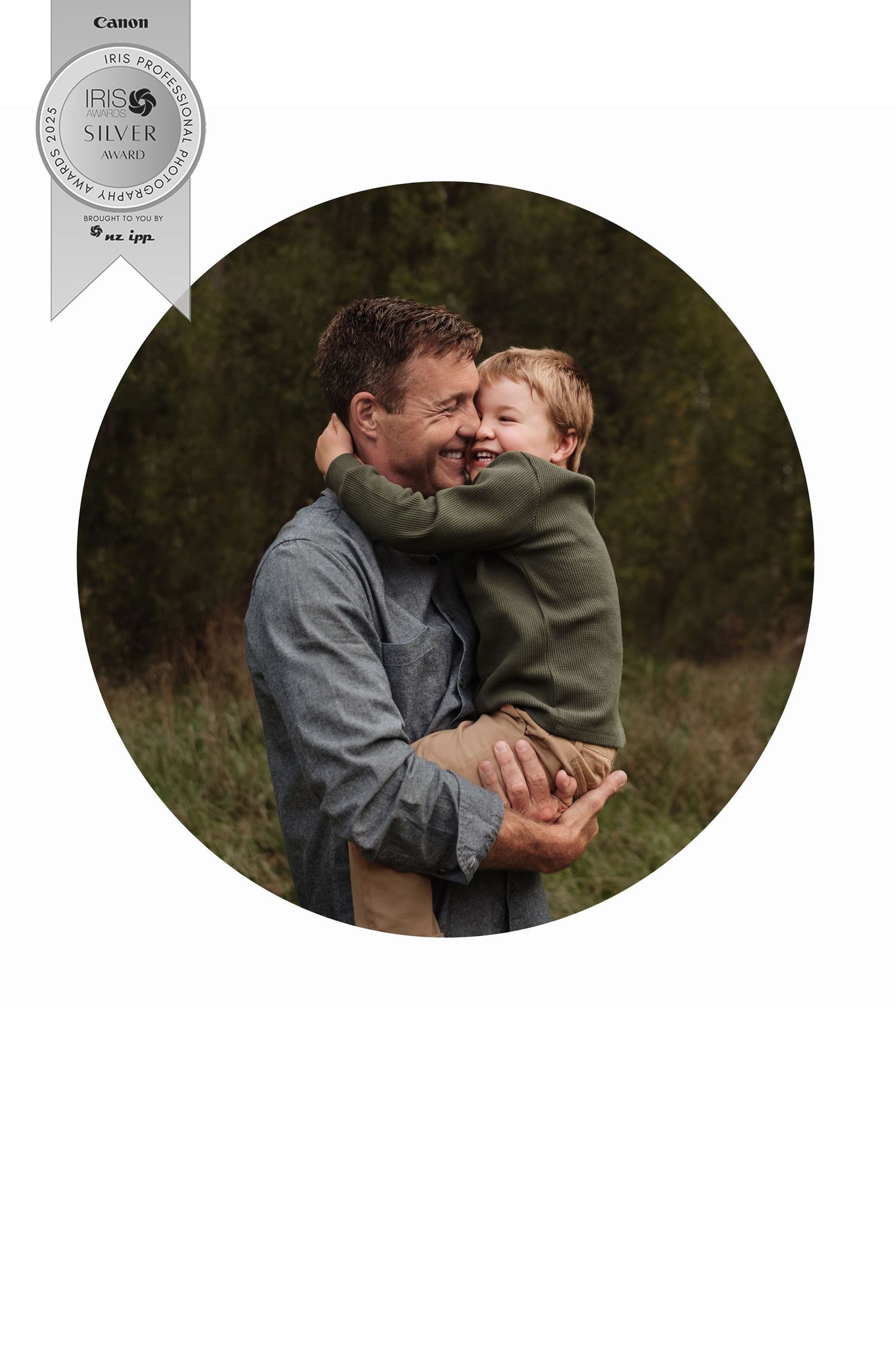 A touching candid moment of warm embrace in a circular frame with dark foliage background.