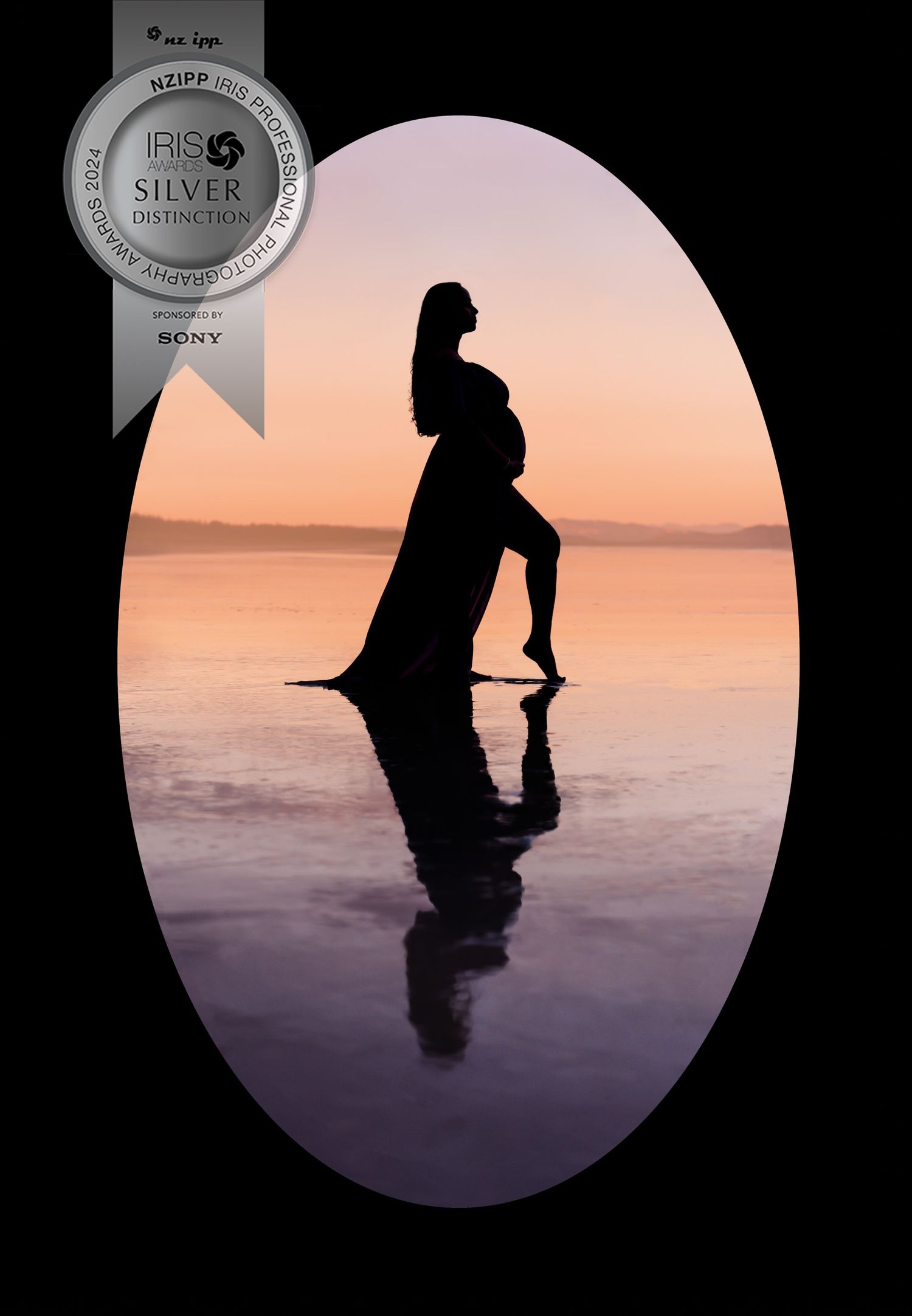 Artistic silhouette of pregnant woman reflected in still water during sunset.
