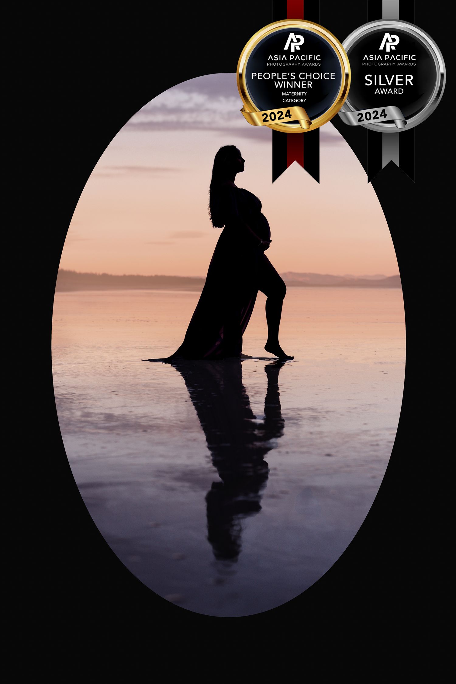 Dramatic silhouette maternity photo with reflection in water during golden hour.