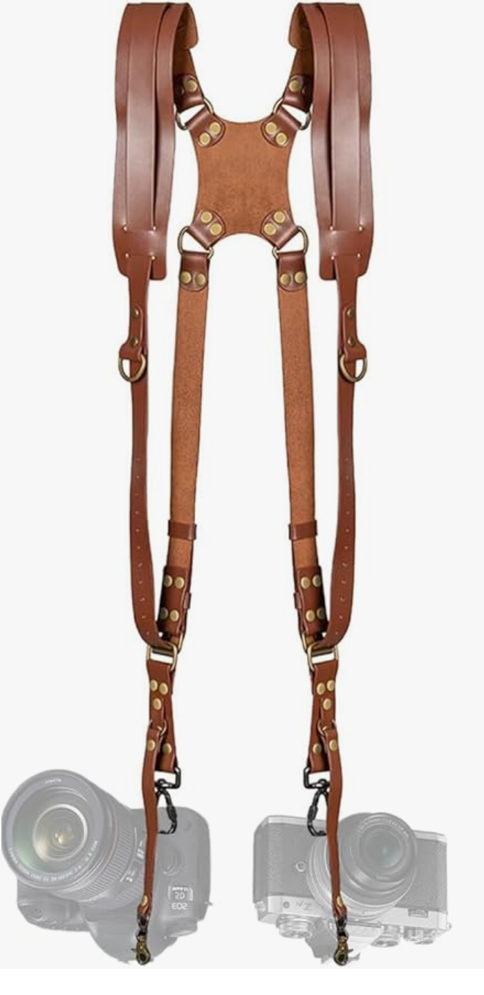 Leather dual camera harness strap system with brass hardware and adjustable straps for professional photographers.
