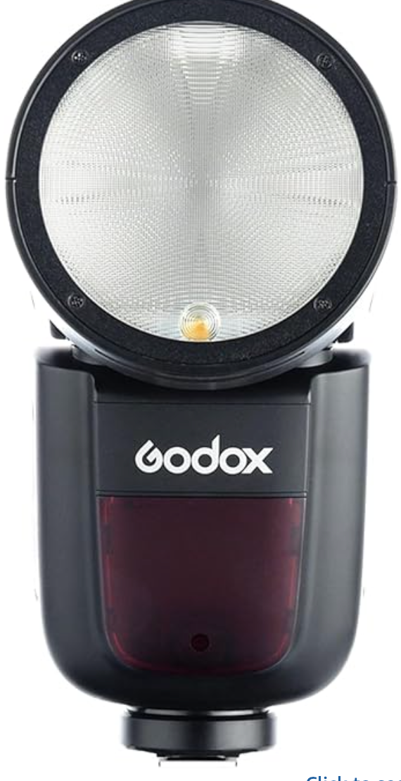 Close-up photo of a Godox camera flash unit with round diffuser head and burgundy-colored sensor panel.