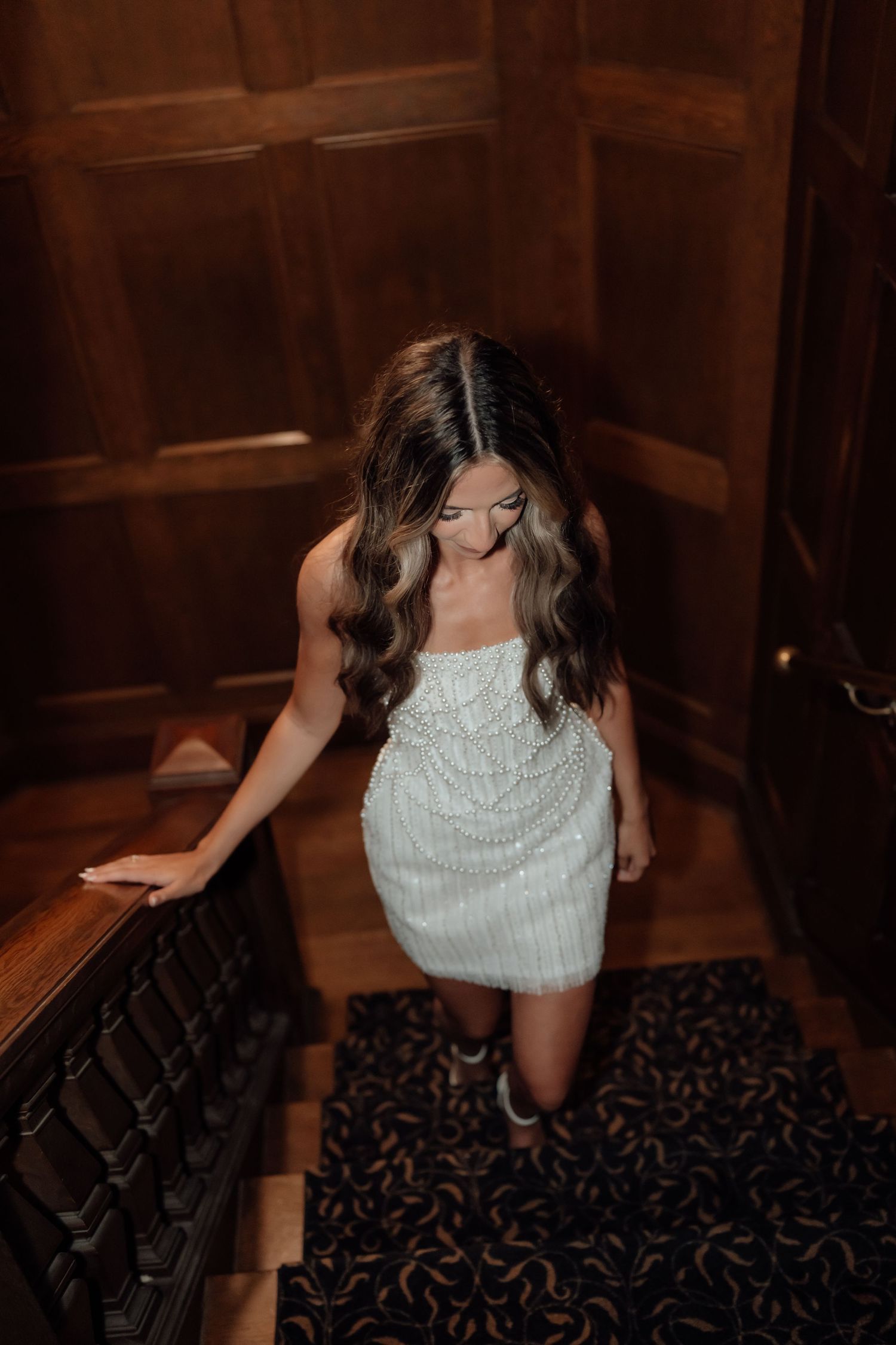 A series of dance poses captured in a dimly lit room with wooden walls and patterned carpet.